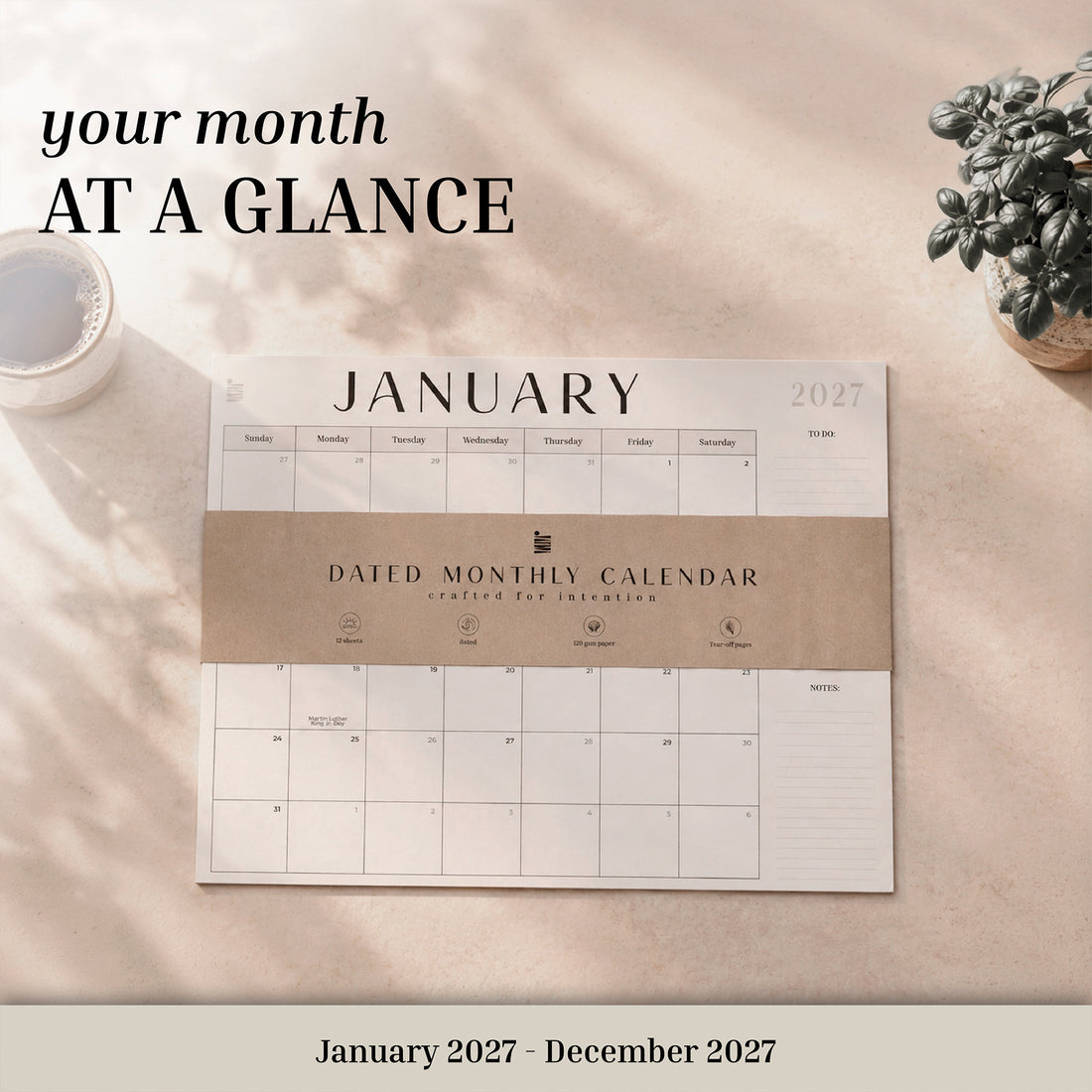 2027 flat desk calendar with its kraft band on a desk, labeled January 2027 to December 2027