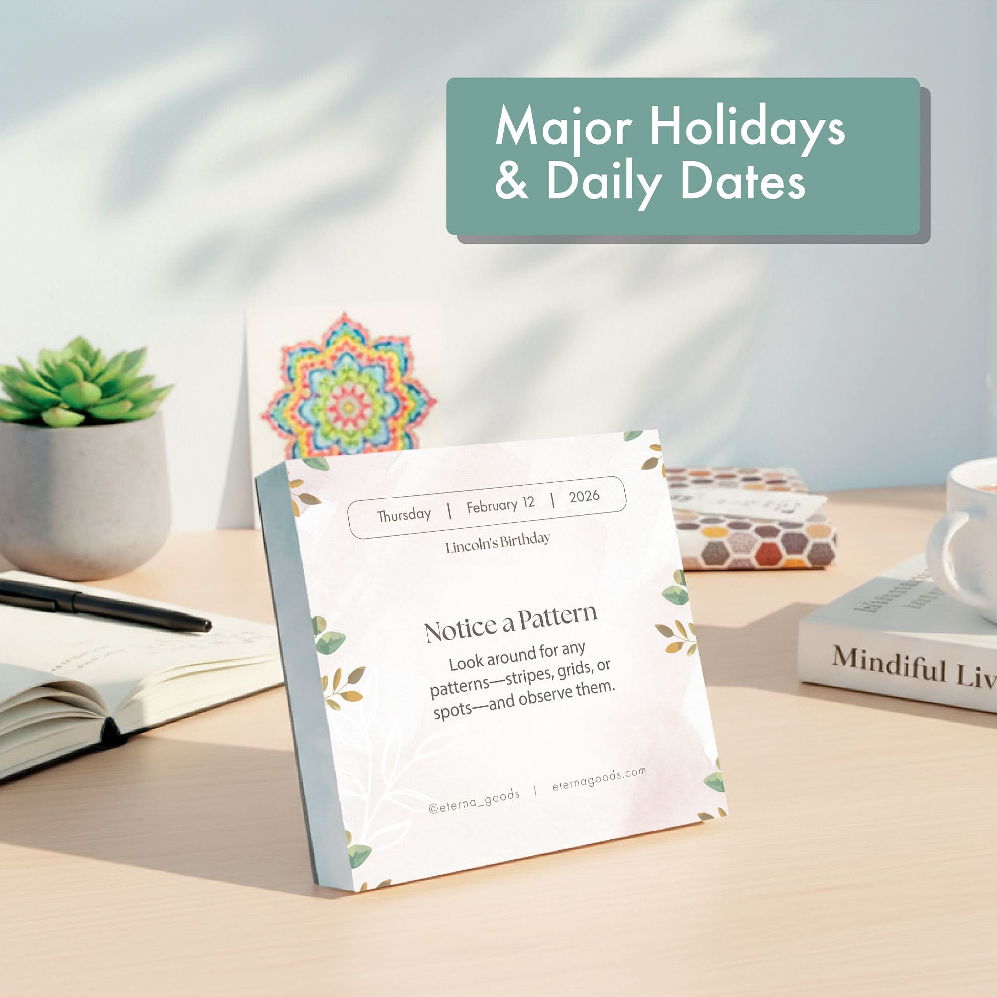 The Eterna Goods 2026 Mindfulness Calendar with tear-off pages shows Thursday, February 12 and a "Notice a Pattern" reminder. It is displayed on a desk with a plant, books, and stationery in the background.