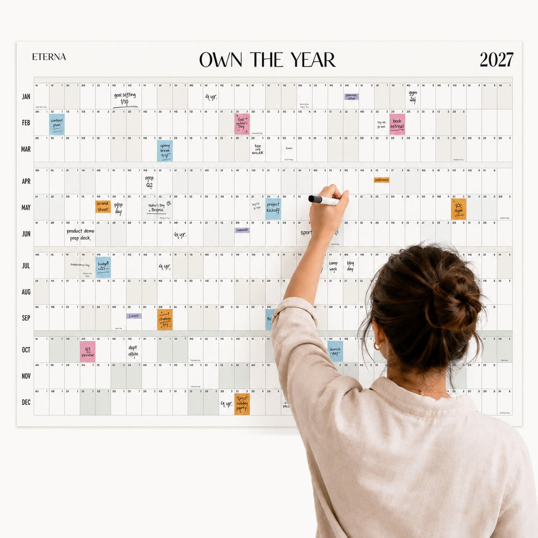Woman writing on the 2027 Dated Own The Year giant dry erase wall calendar