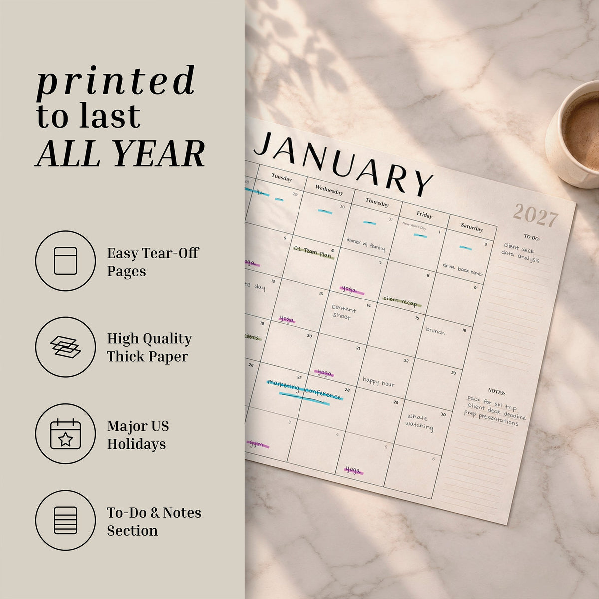 2027 flat desk calendar on a desk with feature icons: tear-off pages, thick paper, US holidays, notes section