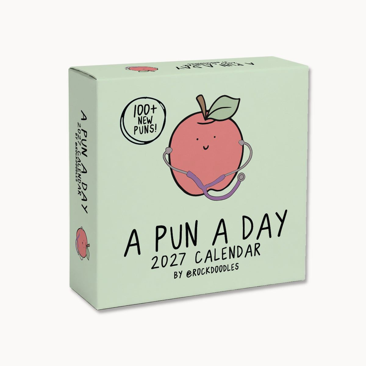 Box for the "2026 A Pun a Day Calendar" by rockdoodles, featuring a cheerful apple with a stethoscope illustration and text showcasing over 100 new puns. This family-friendly daily joke calendar is perfect for anyone who loves to laugh every day!.