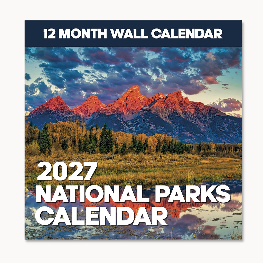 Cover of the 2027 National Parks Wall Calendar by Eterna Goods, showcasing a breathtaking mountain landscape with trees, a tranquil pond, and vivid sunset clouds—an ideal choice for outdoor lovers and fans of beautiful National Park photography.
