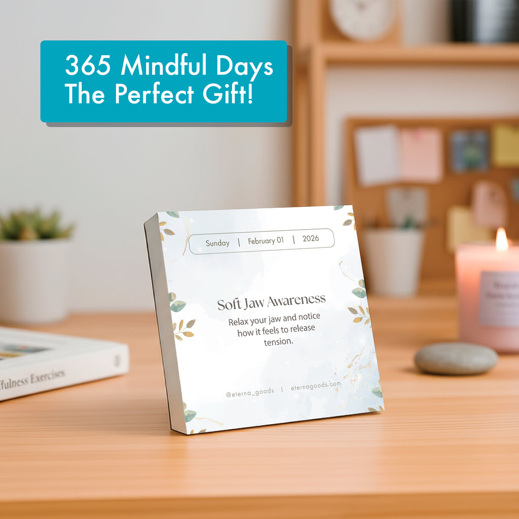 The Eterna Goods 2026 Mindfulness Calendar, featuring daily tear-off pages, sits on a wooden table showing "Soft Jaw Awareness" for Sunday, February 1, 2026—a perfect mindfulness tip for the day.