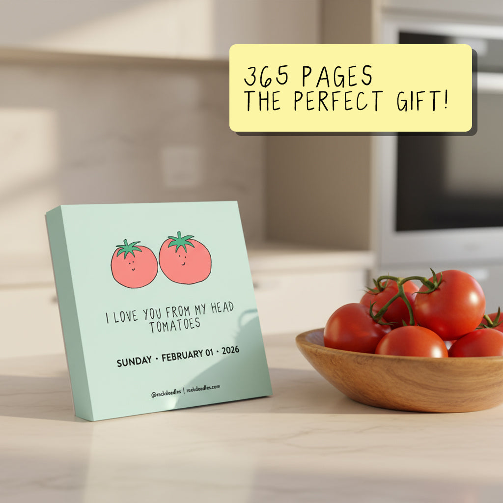 The 2026 A Pun a Day Calendar by rockdoodles, featuring daily puns with two cartoon tomatoes and "I love you from my head tomatoes," sits by a tomato bowl. A sticky note says, "365 pages—the perfect eco-friendly gift!.