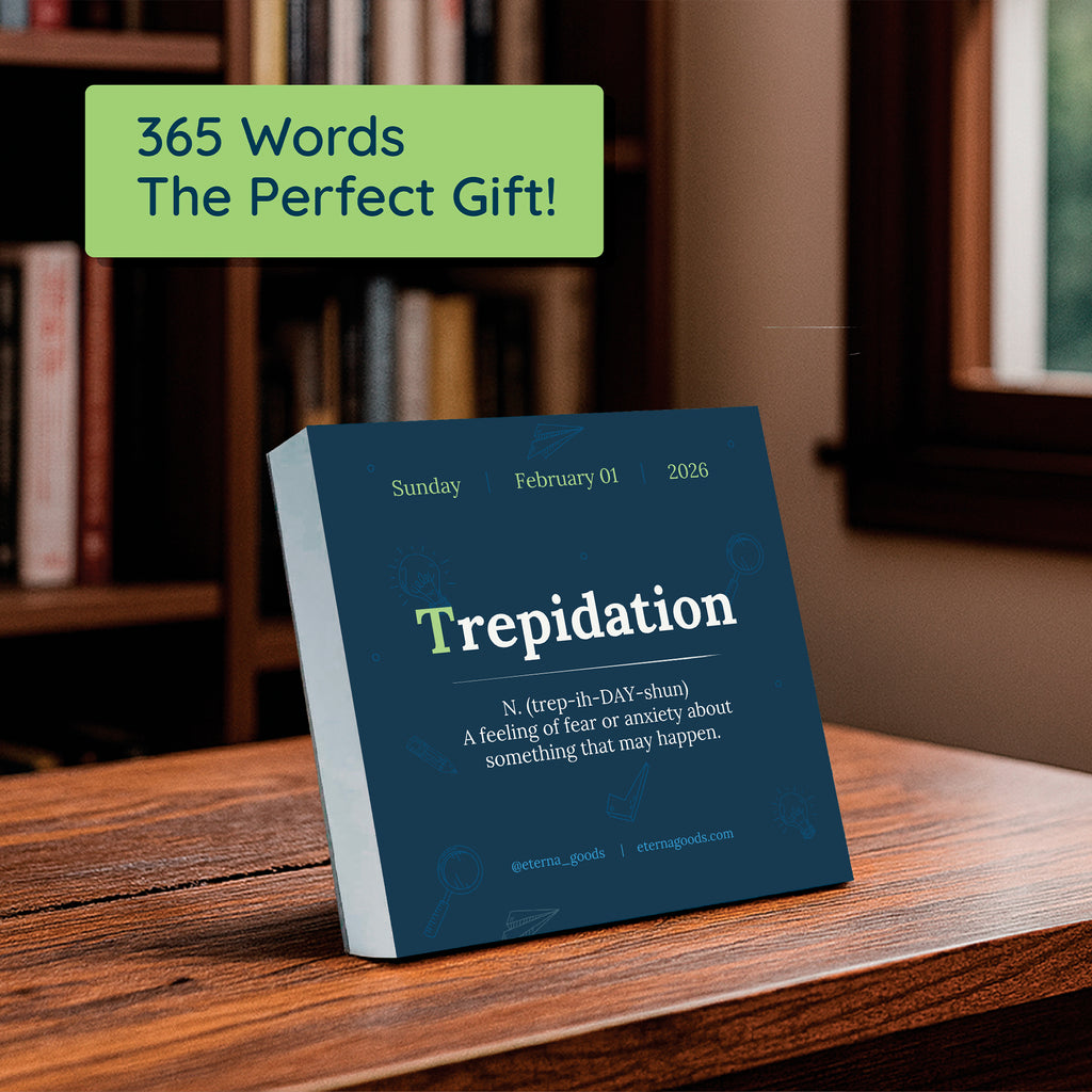 The Eterna Goods 2026 Word Of The Day Calendar sits on a wooden table in front of bookshelves, showing "Trepidation" with its definition for Sunday, February 1—a great gift for word lovers and language enthusiasts.