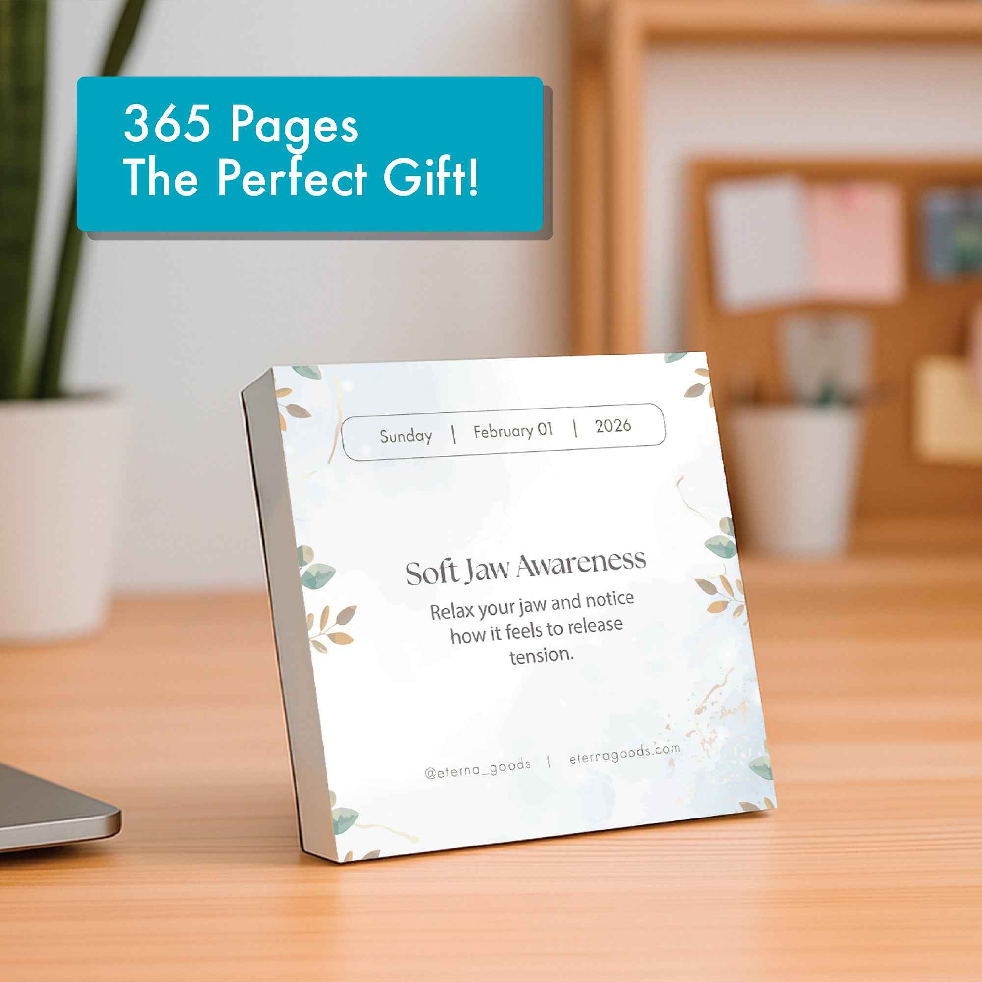 The Eterna Goods 2025 Mindfulness Calendar features "Soft Jaw Awareness," a calming practice, for Sunday, February 1, 2026, displayed on a wooden desk with office supplies in the background.
