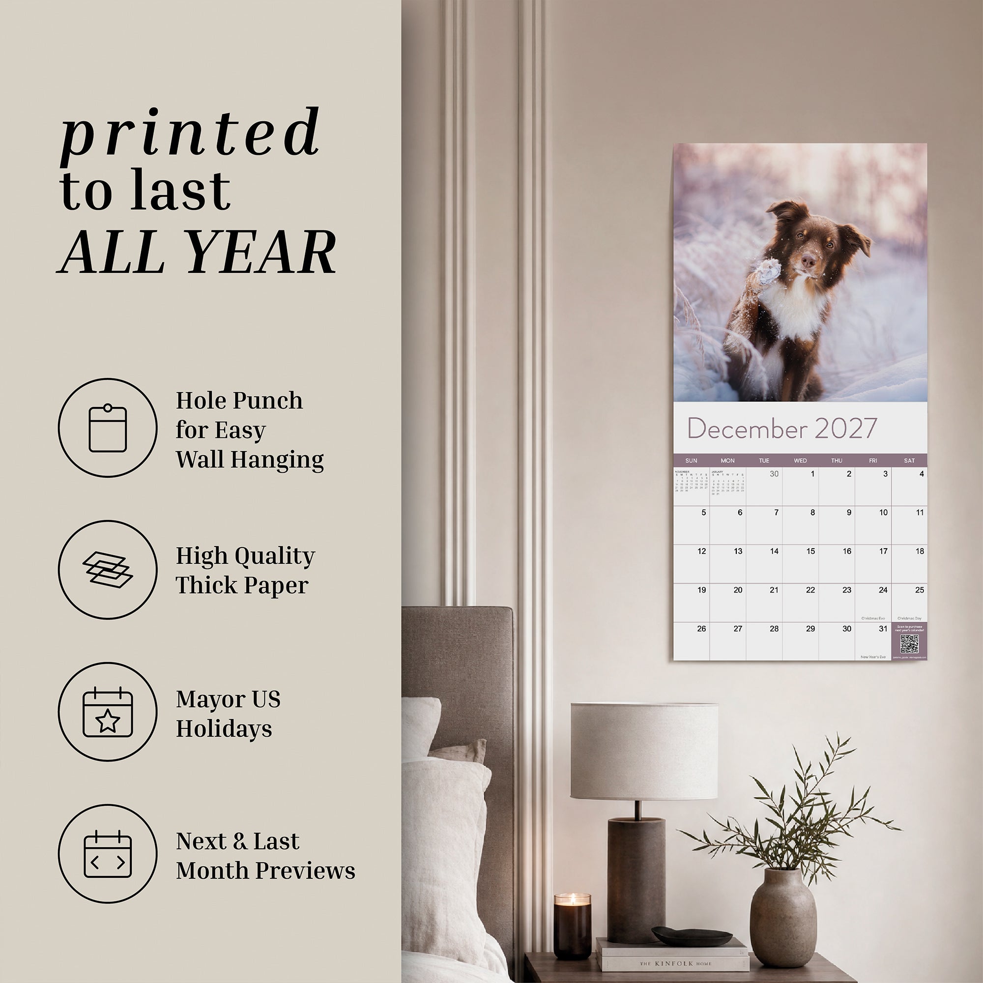 An Eterna Goods 2027 Dogs Wall Calendar, featuring vibrant monthly canine images, hangs above a bedroom desk. Ideal for dog lovers, this calendar highlights key features and details on the left side of the image.