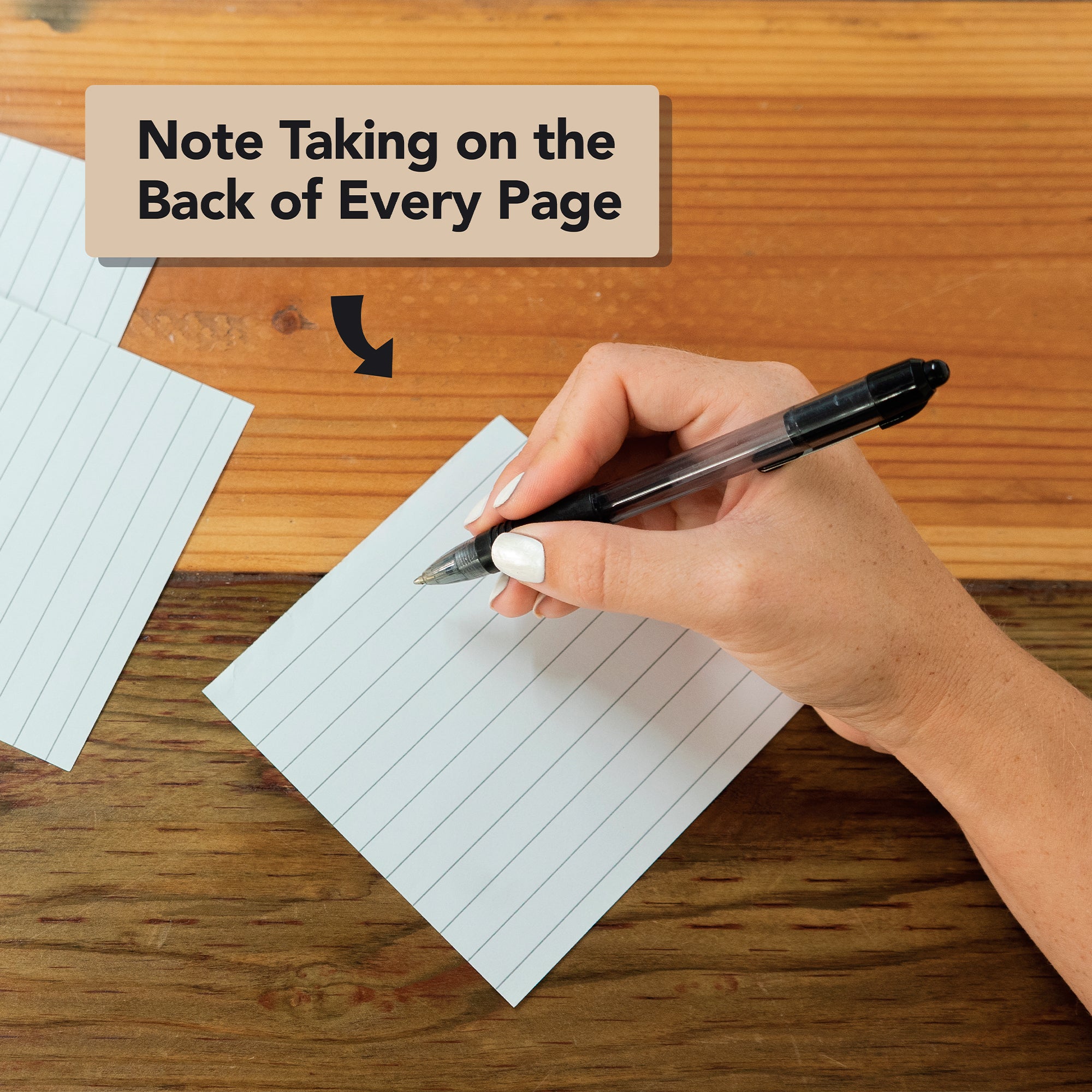A hand writes in large print on the back of an Eterna Goods 2026 Large Text Calendar page—ideal for daily mindfulness journaling or crafting your own mindfulness calendar. "Note Taking on the Back of Every Page" appears above.