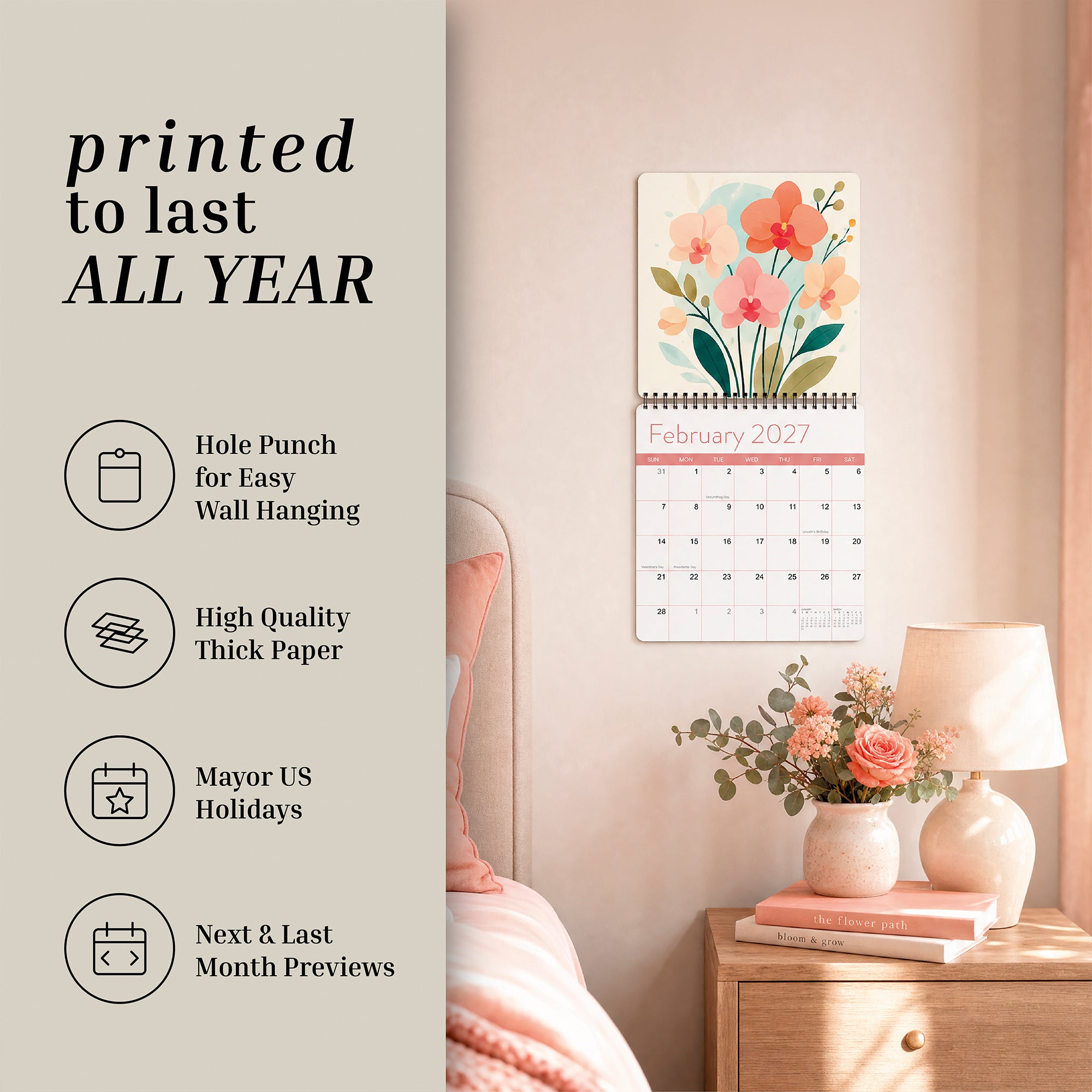 An Eterna Goods 2027 Floral Wall Calendar hangs above a bedside table with a vase of flowers, featuring stunning flower photography and convenient icons for easy hanging, thick paper, US holidays, and handy previews of upcoming months.