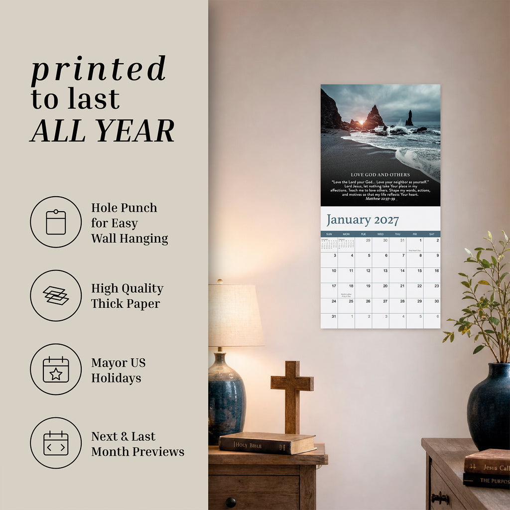 A Hannah Faith 2027 Prayer Wall Calendar hangs above a lamp and decorative objects, showcasing its features—hole punch, thick paper, US holidays, next/last month previews—making it an ideal faith-based gift or a companion to your favorite Bible verse calendar.