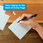 A hand writes on a lined index card with a black pen; above, a sign reads “Note Taking on the Back of Every Page”—a clever way to reuse tear-off pages from Eterna Goods’ 2026 Epic Facts Calendar as sustainable desk accessories.