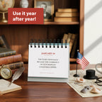 The Today In History Perpetual Calendar by Eterna Goods displays January 1 with a euro currency fact, alongside an American flag, glasses, and books on a wooden desk. "Use it year after year!"—a unique educational gift.