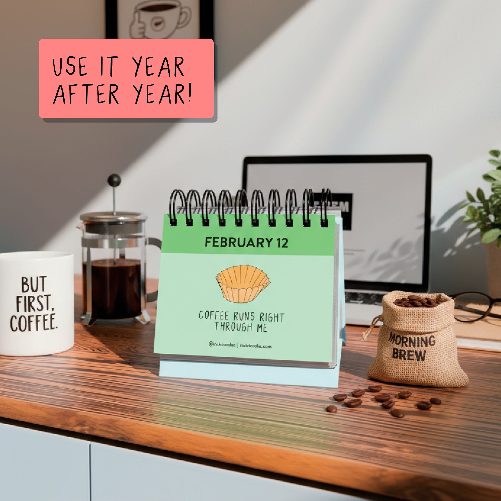 The rockdoodles A Pun A Day Perpetual Calendar, open to February 12, is displayed with coffee mugs, a French press, and a burlap bag on a wooden desk. "USE IT YEAR AFTER YEAR!"—a fun wordplay gift for coffee lovers.