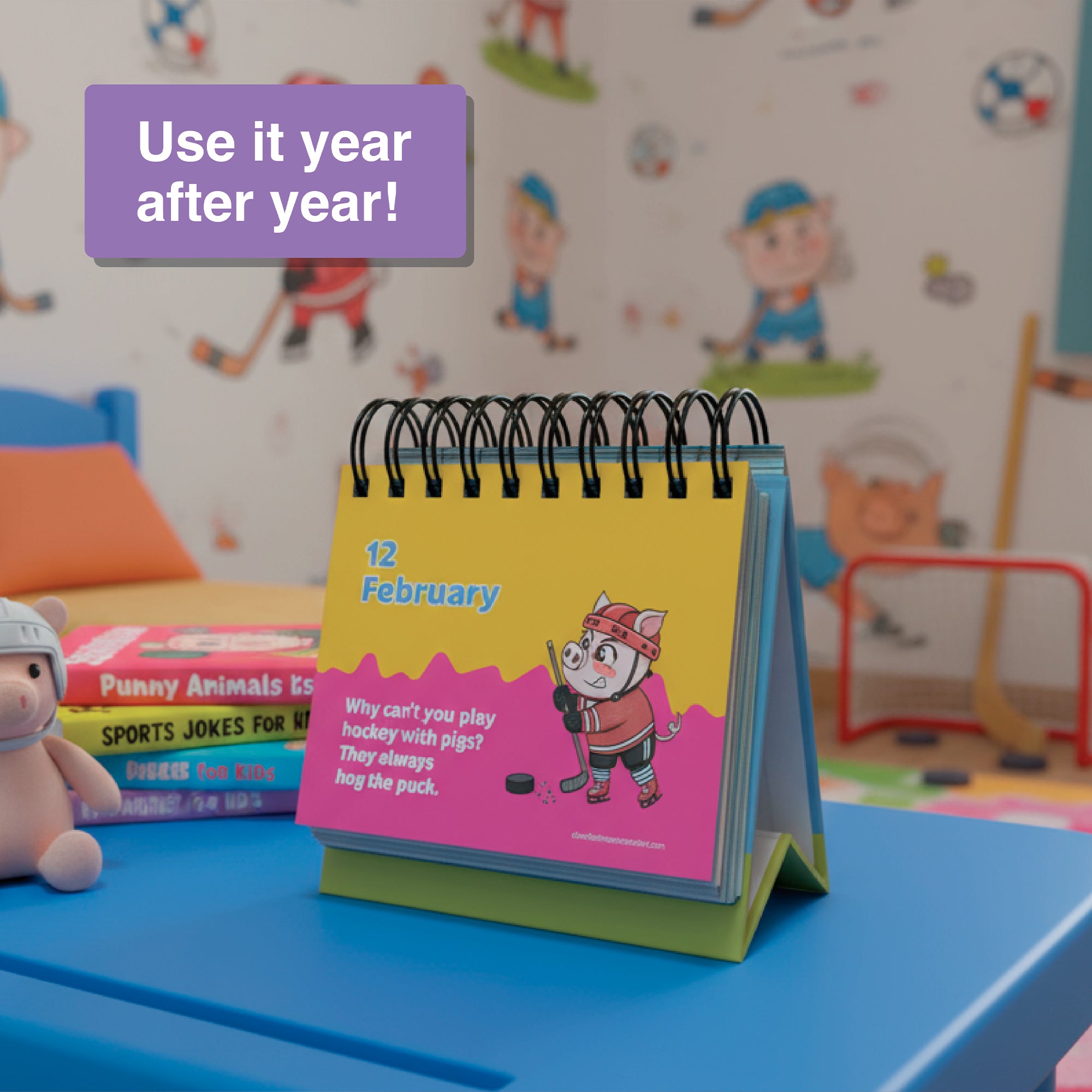 The Perpetual Kids Jokes Calendar by Charlie's Treasures is open to February 12, featuring a cartoon animal playing hockey, displayed on a blue desk in a child's room with animal-themed wallpaper.