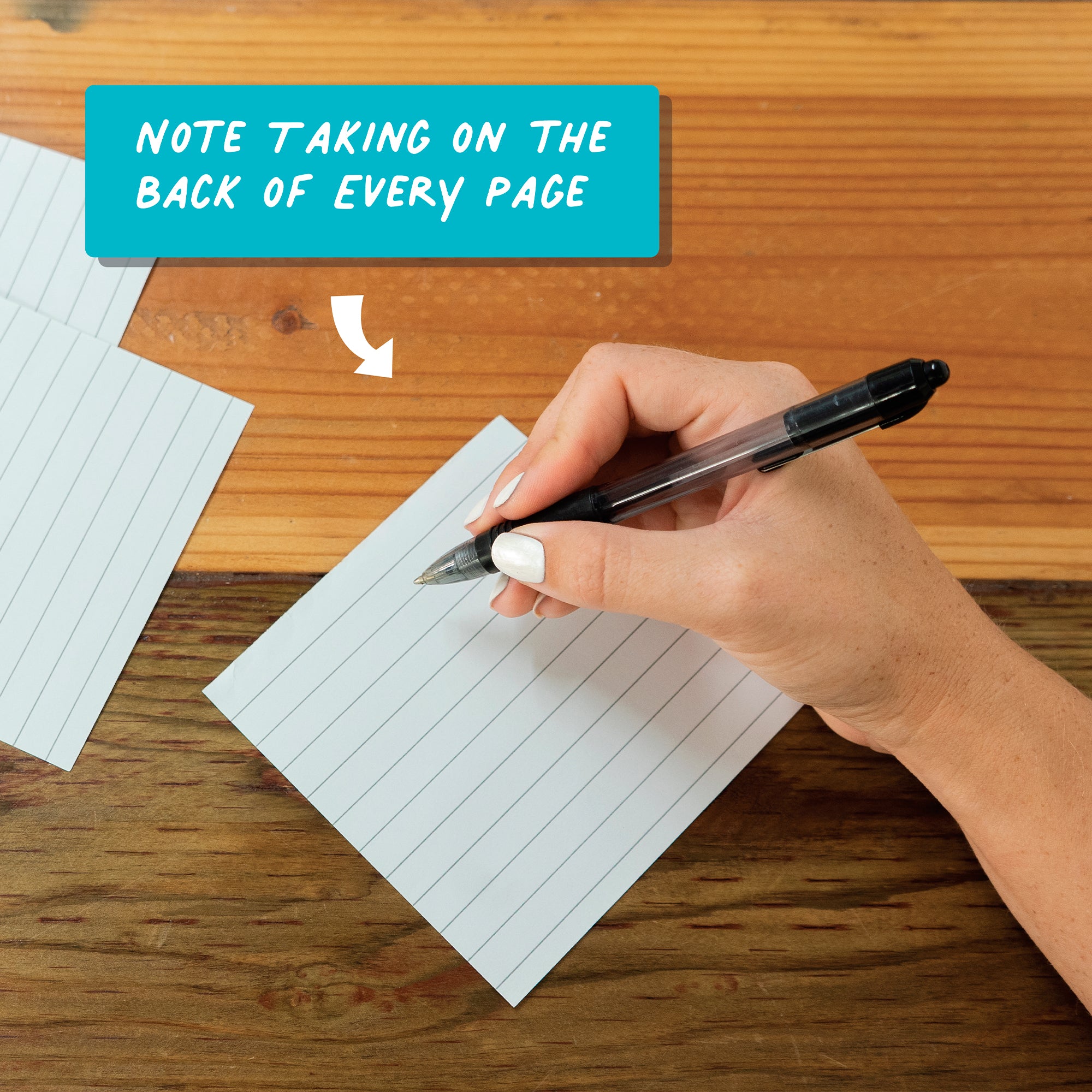 A hand writes on the back of a lined index card with a black pen; text box says, "Note taking on the back of every page—a perfect complement to your Charlie's Treasures Kids Coloring Calendar.