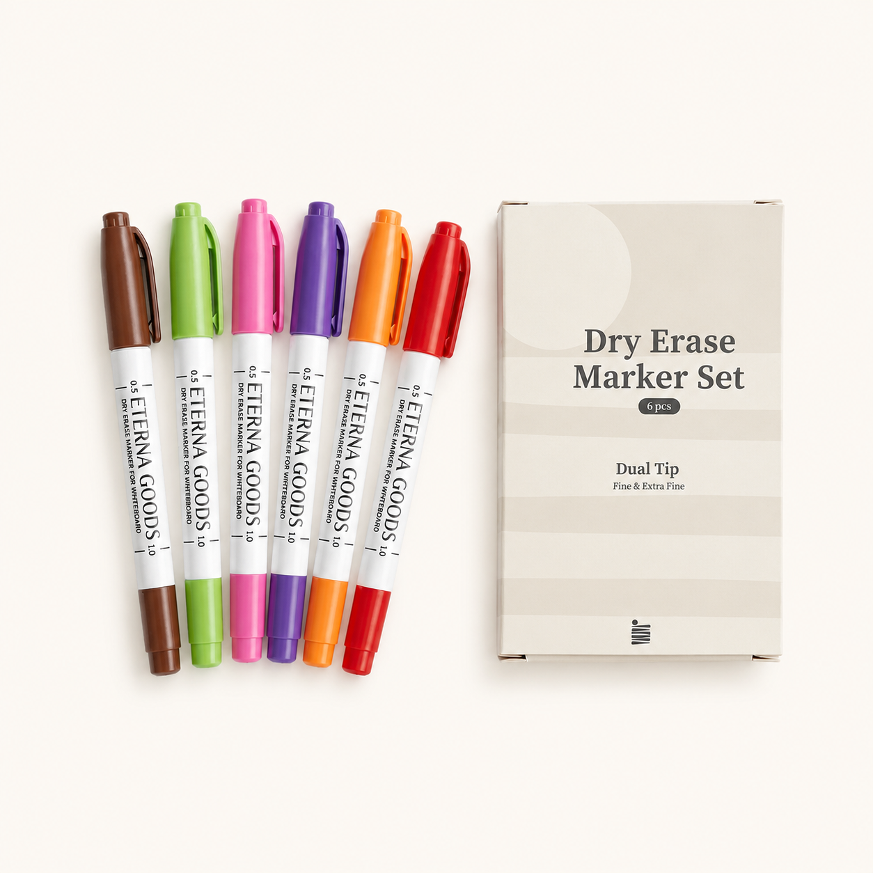 Six fine tip dry erase markers from Eterna Goods (brown, green, orange, purple, pink, red) with quick-drying ink are arranged next to a box labeled "Fine Tip Dry Erase Marker Set.