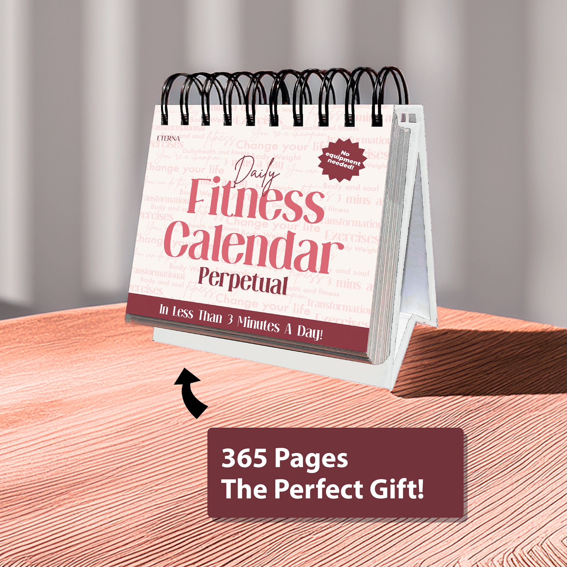 A Perpetual Fitness Calendar by Eterna Goods sits on a wooden surface, featuring text "365 Pages The Perfect Gift!" and an arrow pointing to the calendar.