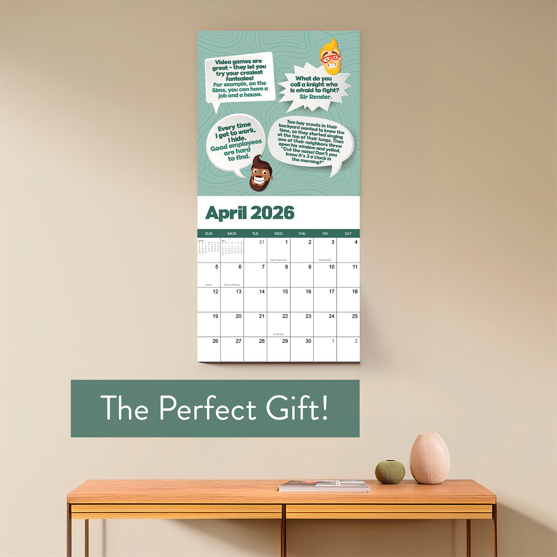 A 2026 Dad Joke Wall Calendar by That Is So Dad hangs above a wooden table with small vases; the text "The Perfect Gift!" is displayed below the calendar.