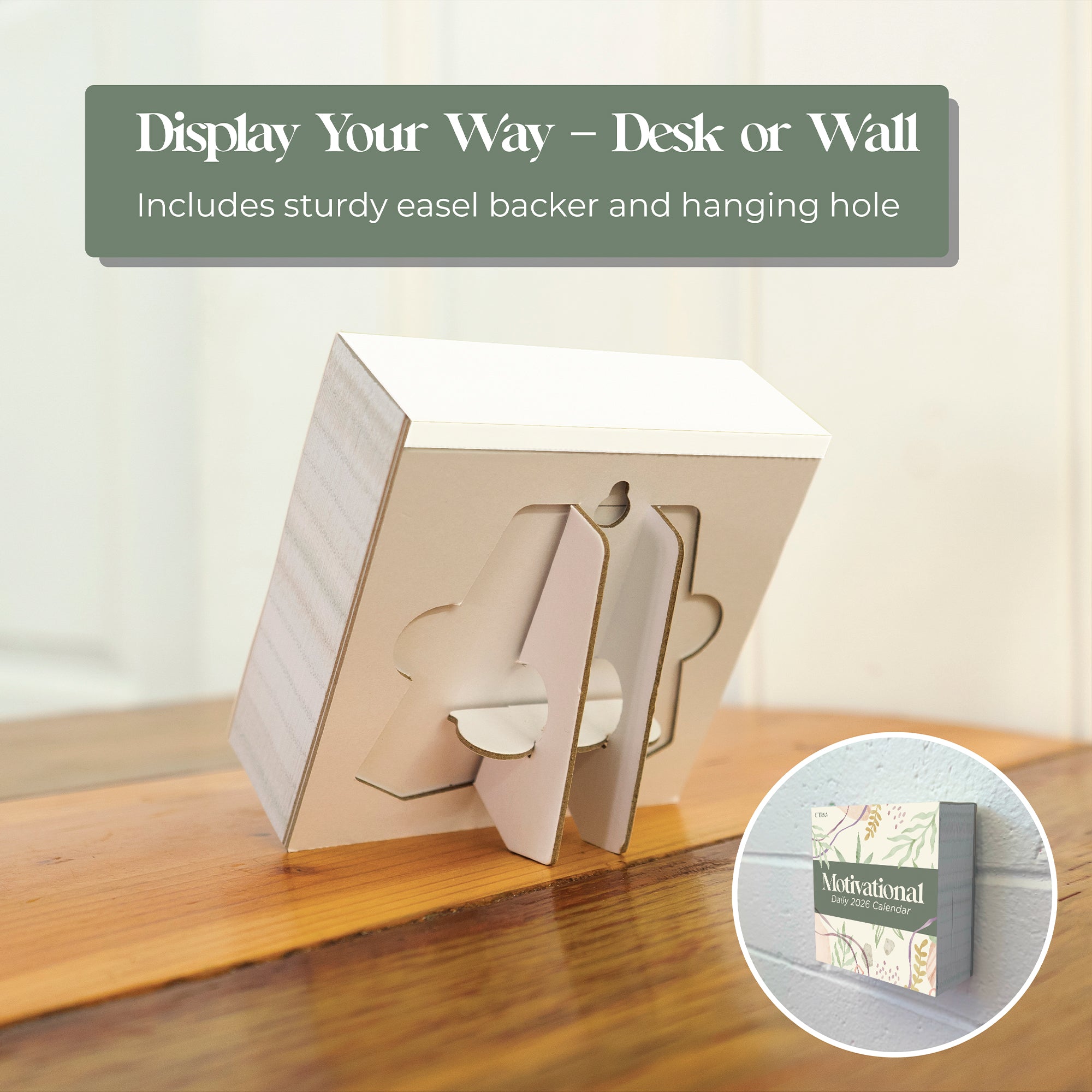 The Eterna Goods 2026 Motivational Calendar stands on a wooden surface with a sturdy easel backer; an inset shows it hanging on the wall, featuring daily motivational messages in a convenient tear-off desk calendar design.