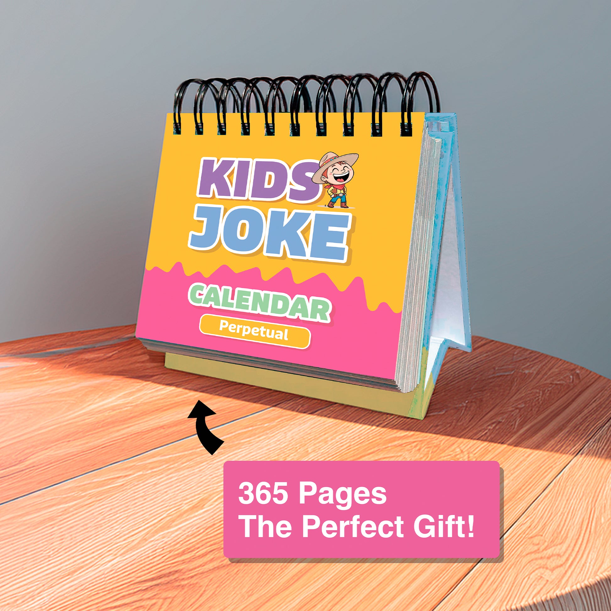 Charlie's Treasures' Perpetual Kids Jokes Calendar with spiral binding sits on a wooden table. The label highlights 365 pages and calls it "The Perfect Gift!.