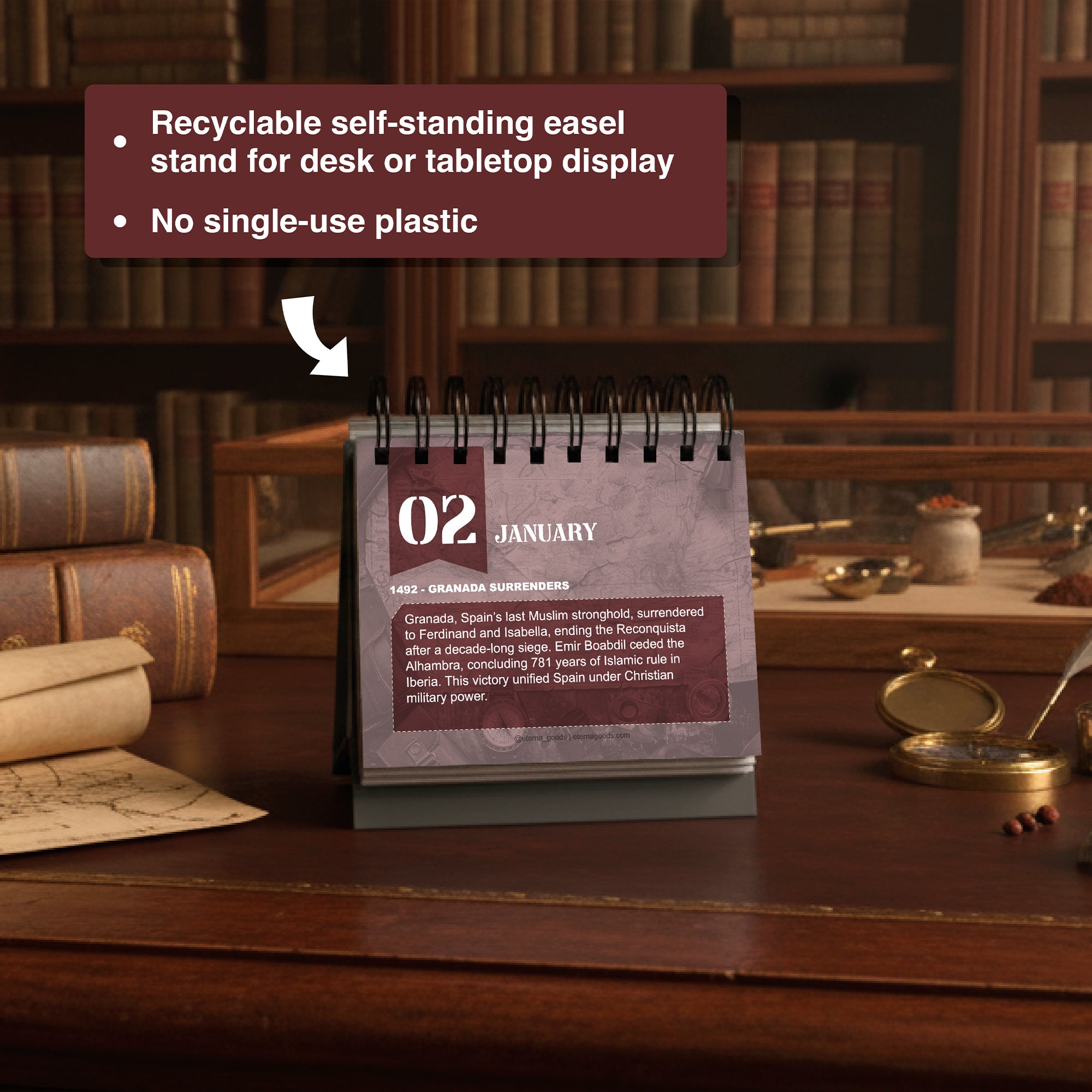 The Today In Military History Perpetual Calendar by Eterna Goods displays January 2 on a wooden table in a library, surrounded by books and a magnifying glass; accompanying text notes its eco-friendly features.