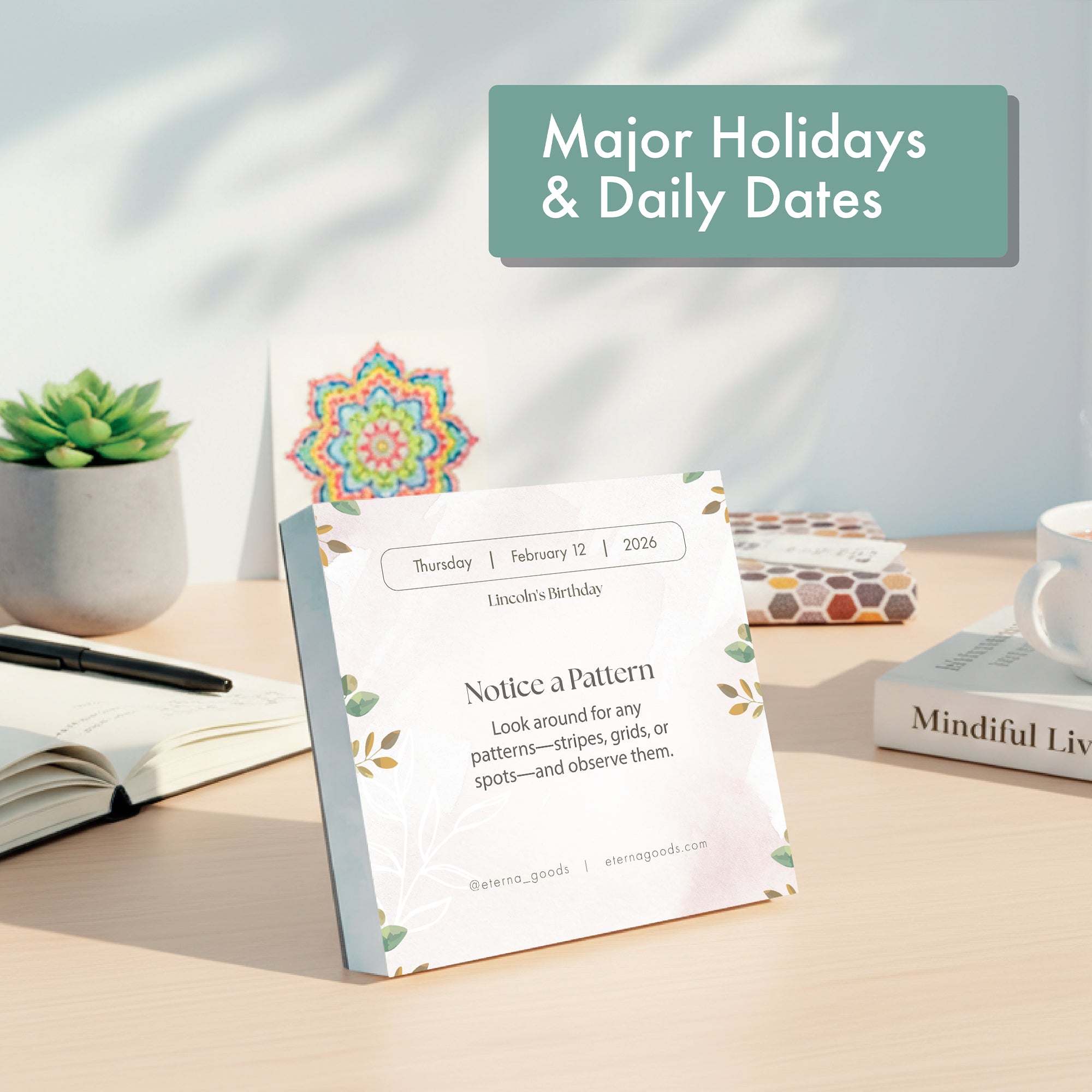 The Eterna Goods 2026 Mindfulness Calendar with tear-off pages shows Thursday, February 12 and a "Notice a Pattern" reminder. It is displayed on a desk with a plant, books, and stationery in the background.