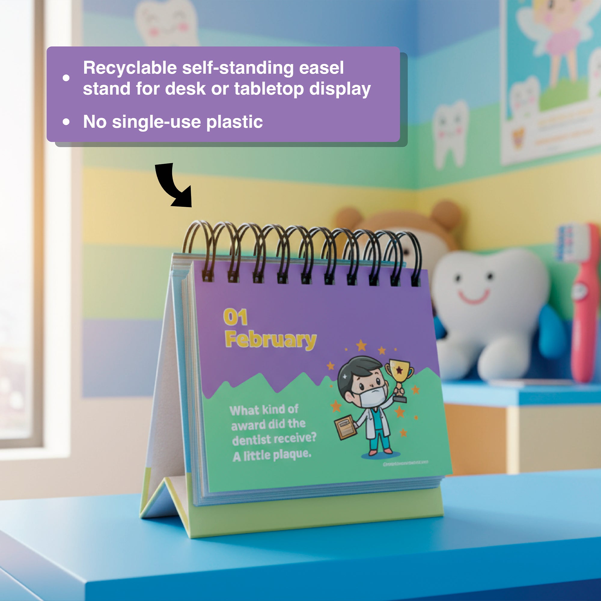 Charlie's Treasures Perpetual Kids Jokes Calendar sits spiral-bound on a blue table, open to a dental joke for Feb 1. A label notes its recyclable stand and that it's free from single-use plastic.