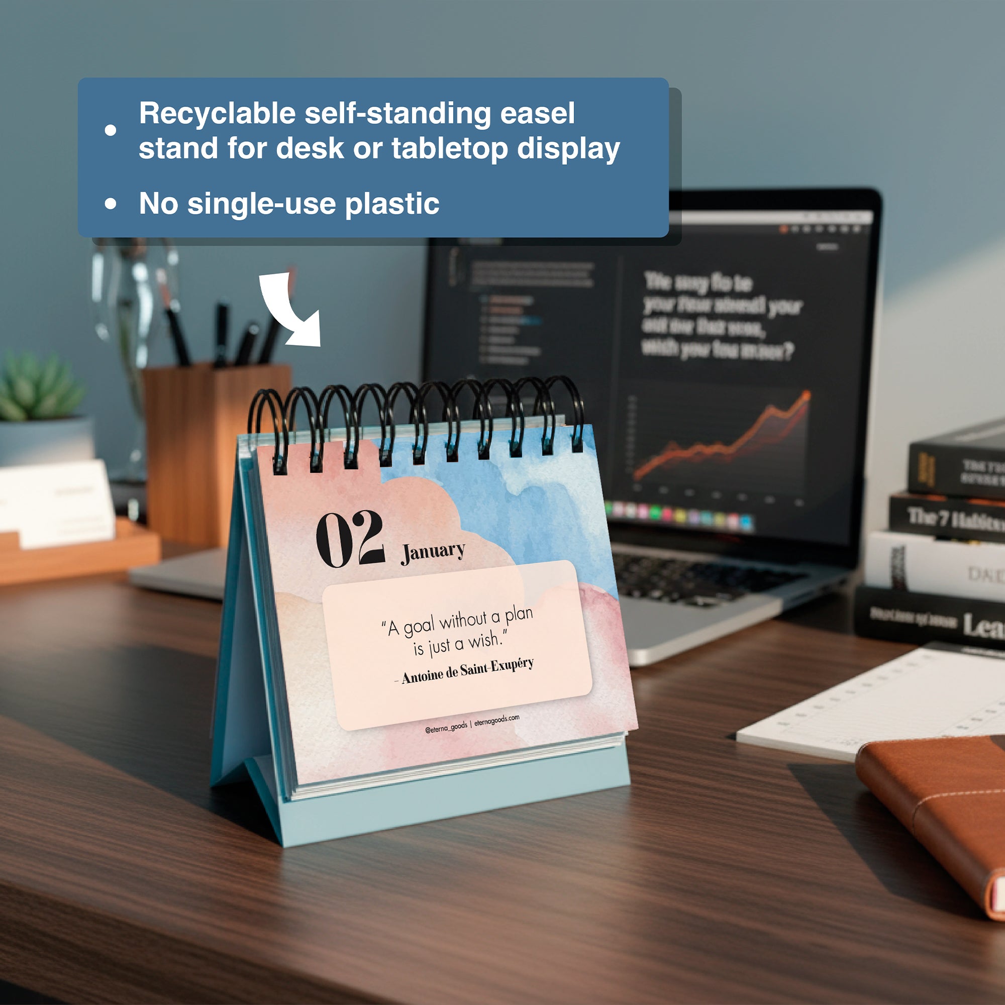 The Eterna Goods Motivational Perpetual Calendar sits on a desk by a laptop and books, featuring an inspiring quote for January 2. Eco-friendly features of the product are also highlighted in the text.