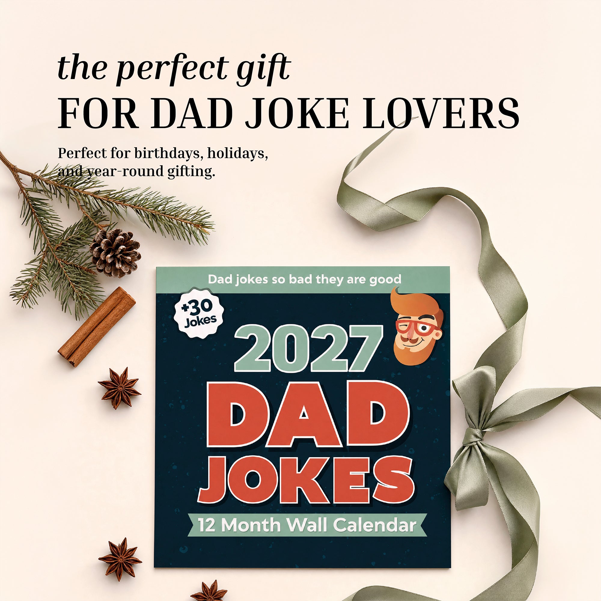 The 2027 Dad Joke Wall Calendar by That Is So Dad is displayed with a ribbon, pine branch, cinnamon sticks, and star anise on a beige background. This hilarious calendar is the perfect gift for fans of dad jokes.