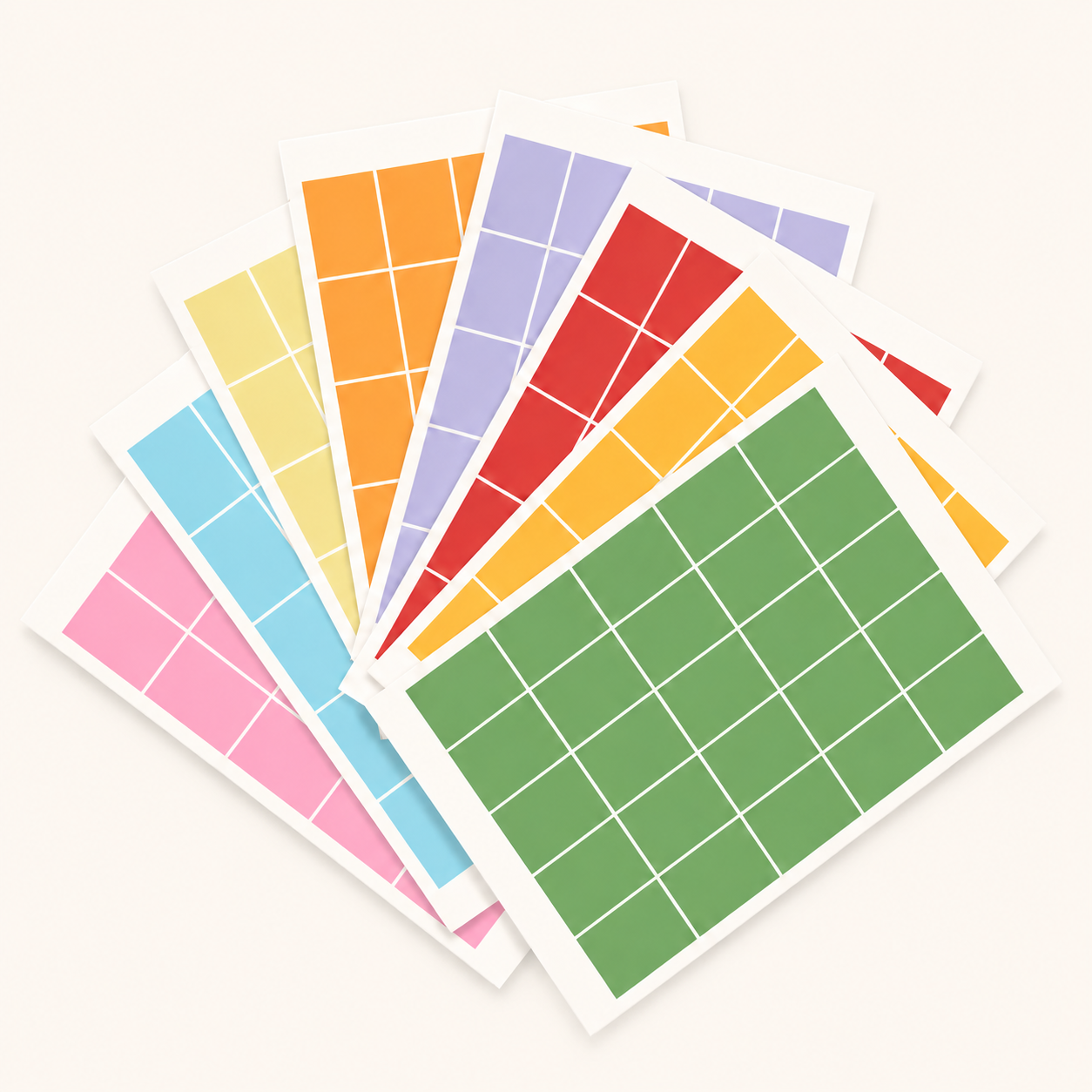 Eight sheets of Eterna Goods' Planning Block Stickers, each featuring a grid of colored squares in pink, blue, yellow, orange, purple, red, light orange, and green—ideal for organizing your big wall calendar—are fanned out against a neutral backdrop.
