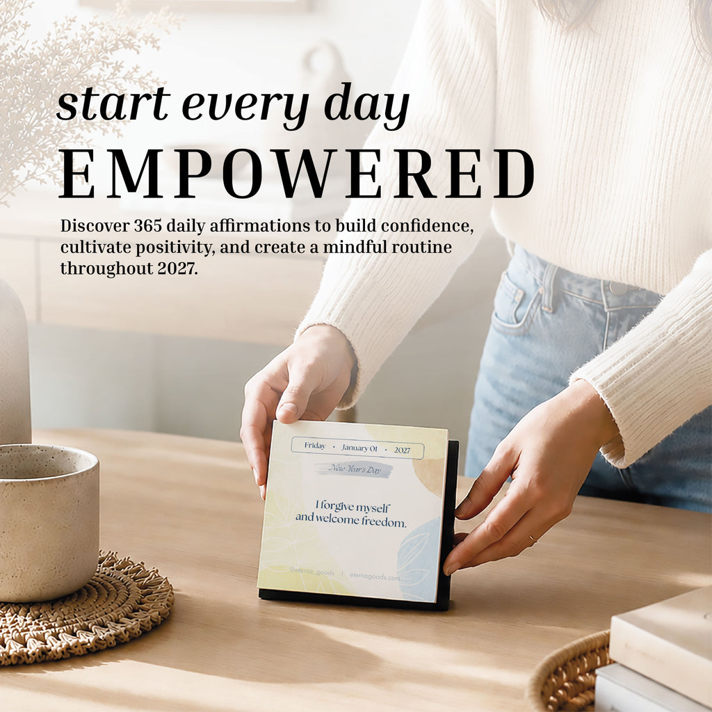 A person flips a page on the Eterna Goods 2027 Daily Affirmations Calendar, revealing a new uplifting affirmation. Text overlay encourages starting every day empowered with confidence and mindfulness.