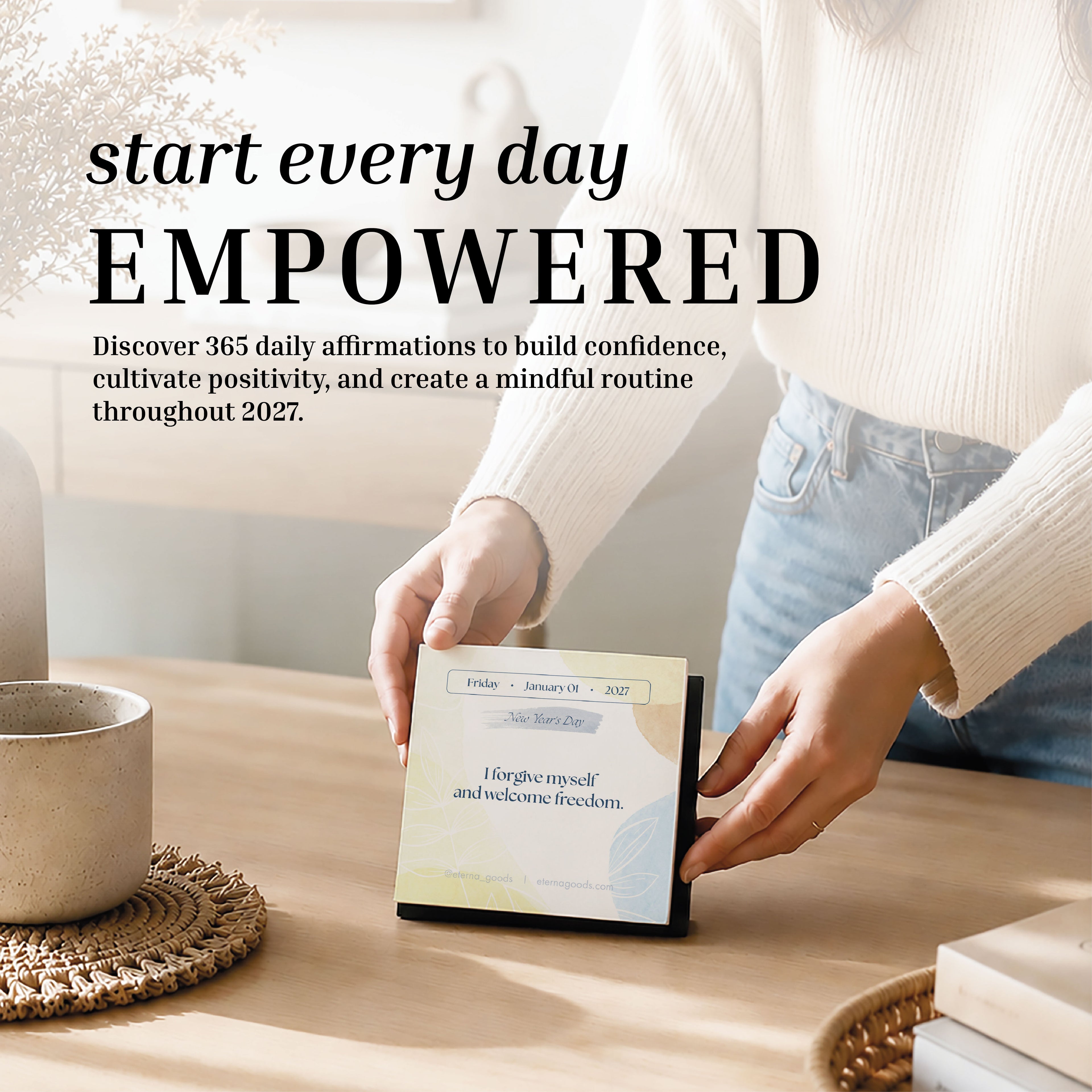 A person flips a page on the Eterna Goods 2027 Daily Affirmations Calendar, revealing a new uplifting affirmation. Text overlay encourages starting every day empowered with confidence and mindfulness.