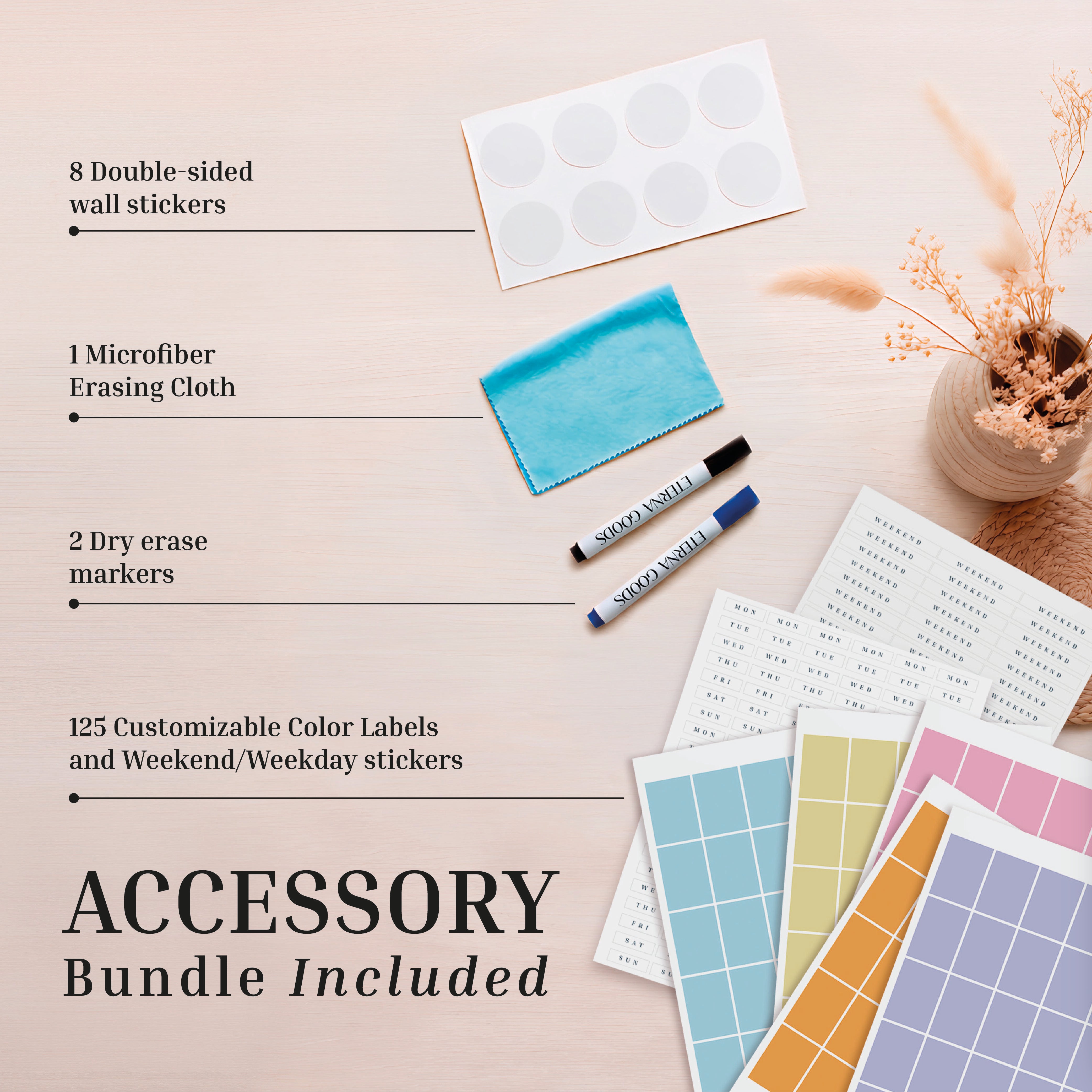 Flat lay of Eterna Goods' Undated Own The Year Calendar accessory bundle: wall stickers, microfiber cloth, two dry erase markers, and customizable color labels with weekend and weekday stickers displayed on a wooden surface.