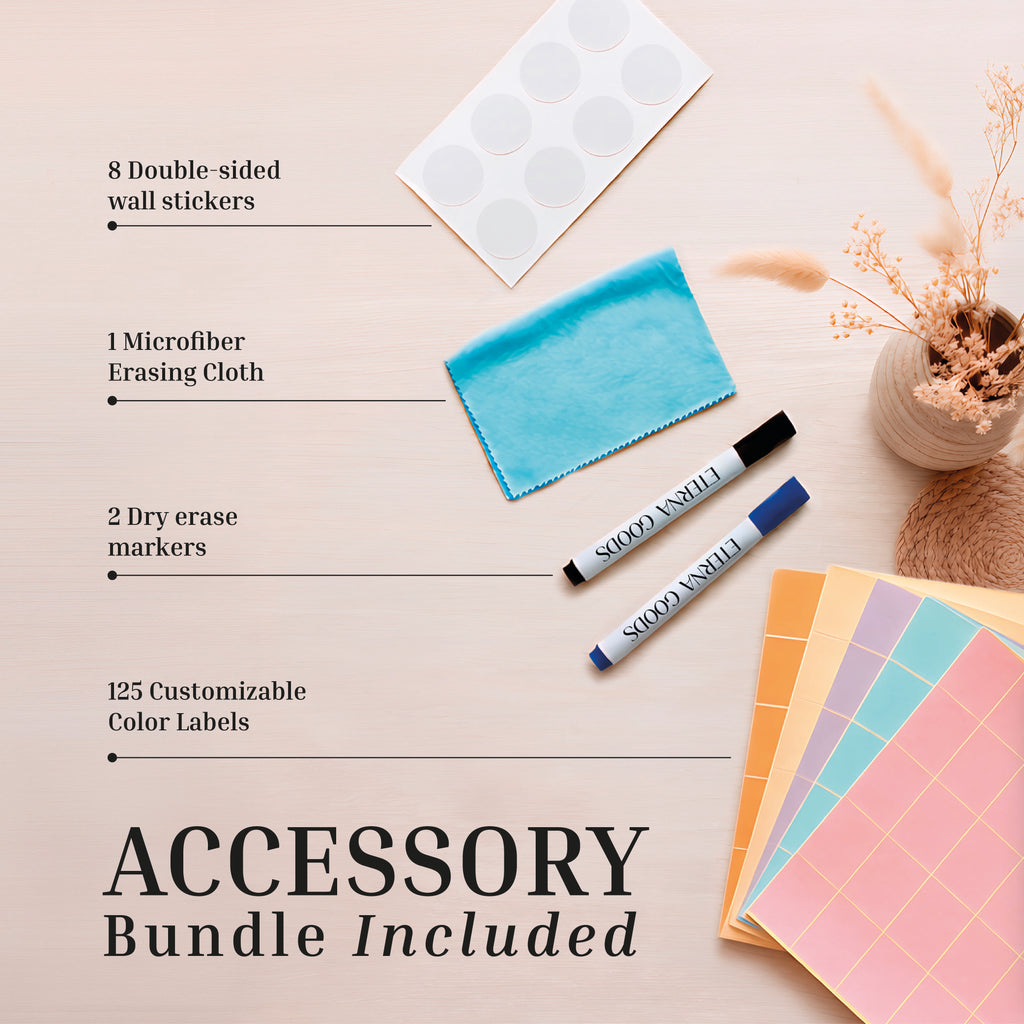 The accessory bundle for the Eterna Goods Undated Own The Year Calendar includes 8 wall stickers, 1 microfiber cloth, 2 dry erase markers, and 125 color labels—perfect for pairing with your giant dry erase calendar—shown on a light wood surface with dried flowers.