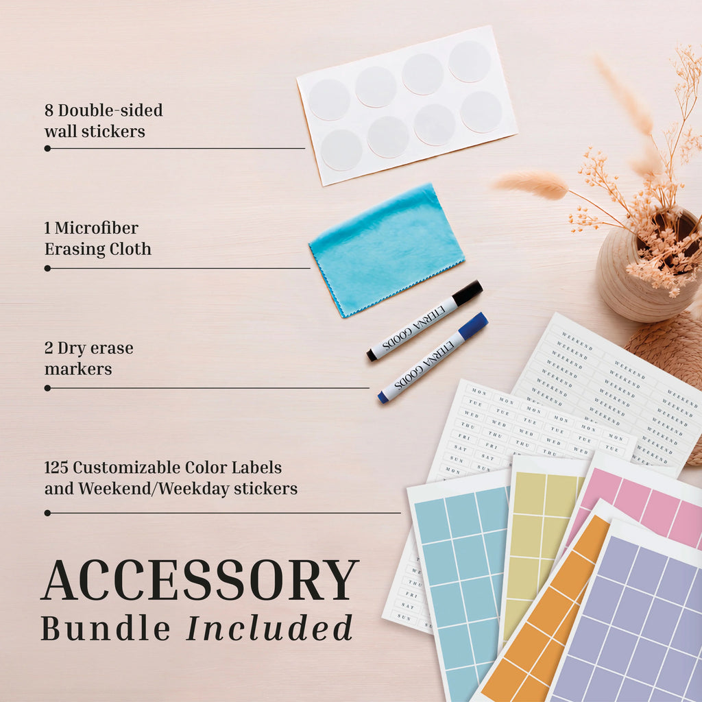 Upgrade your planning with the Eterna Goods Own The Year Midyear / Academic Calendar accessory bundle, featuring wall stickers, weekday stickers, color labels, dry erase markers, and a microfiber cloth—all beautifully arranged on a light wood surface alongside a vase of dried flowers.