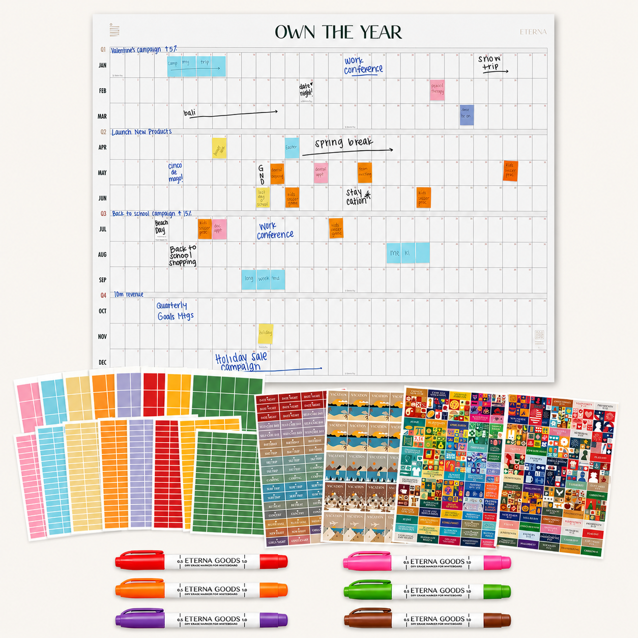 The Ultimate Undated Own The Year Calendar Bundle by Eterna Goods features a white undated wall calendar that doubles as a yearly planner, accompanied by color-coded sticky notes, markers, and vibrant stickers—everything you need to label, organize, and plan your events and tasks with essential accessories.