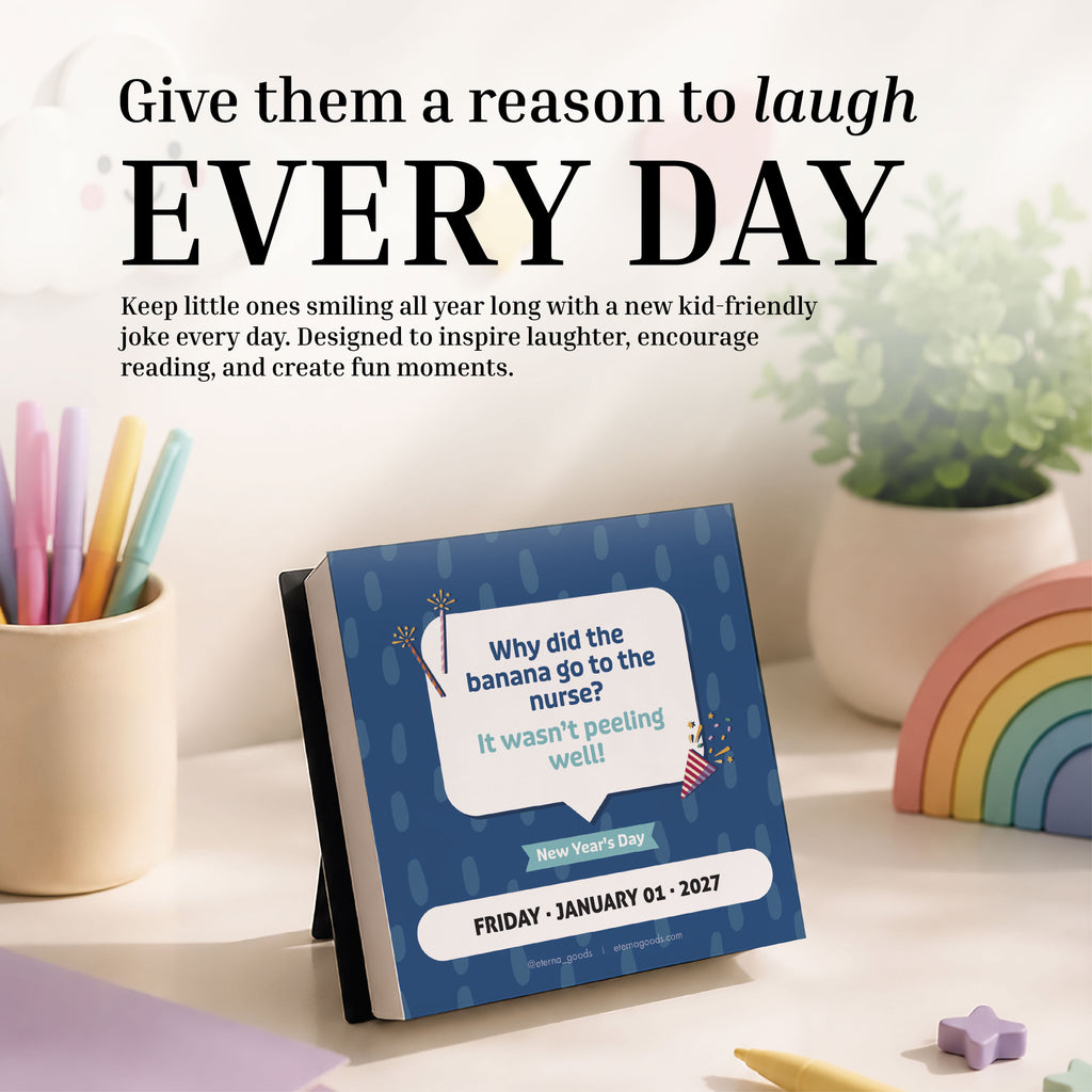 The 2026 Kids Jokes Calendar by Charlie's Treasures sits atop a pastel desk, surrounded by colorful pens, a rainbow decoration, a unicorn cup, and a cheerful green potted plant—making it the perfect gift for daily giggles and kid-friendly jokes.