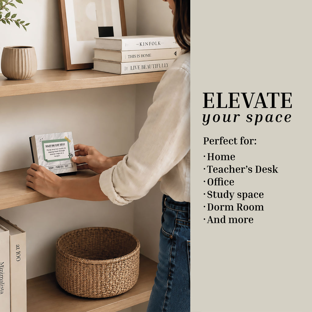 A woman arranges decor on a wooden shelf; the text reads, "Elevate your space. Perfect for: Home, Teacher's Desk, Office, Study space, Dorm Room, and more." Pair your decor with the Eterna Goods 2027 Daily Life Hacks Calendar for effortless organization and daily productivity tips.