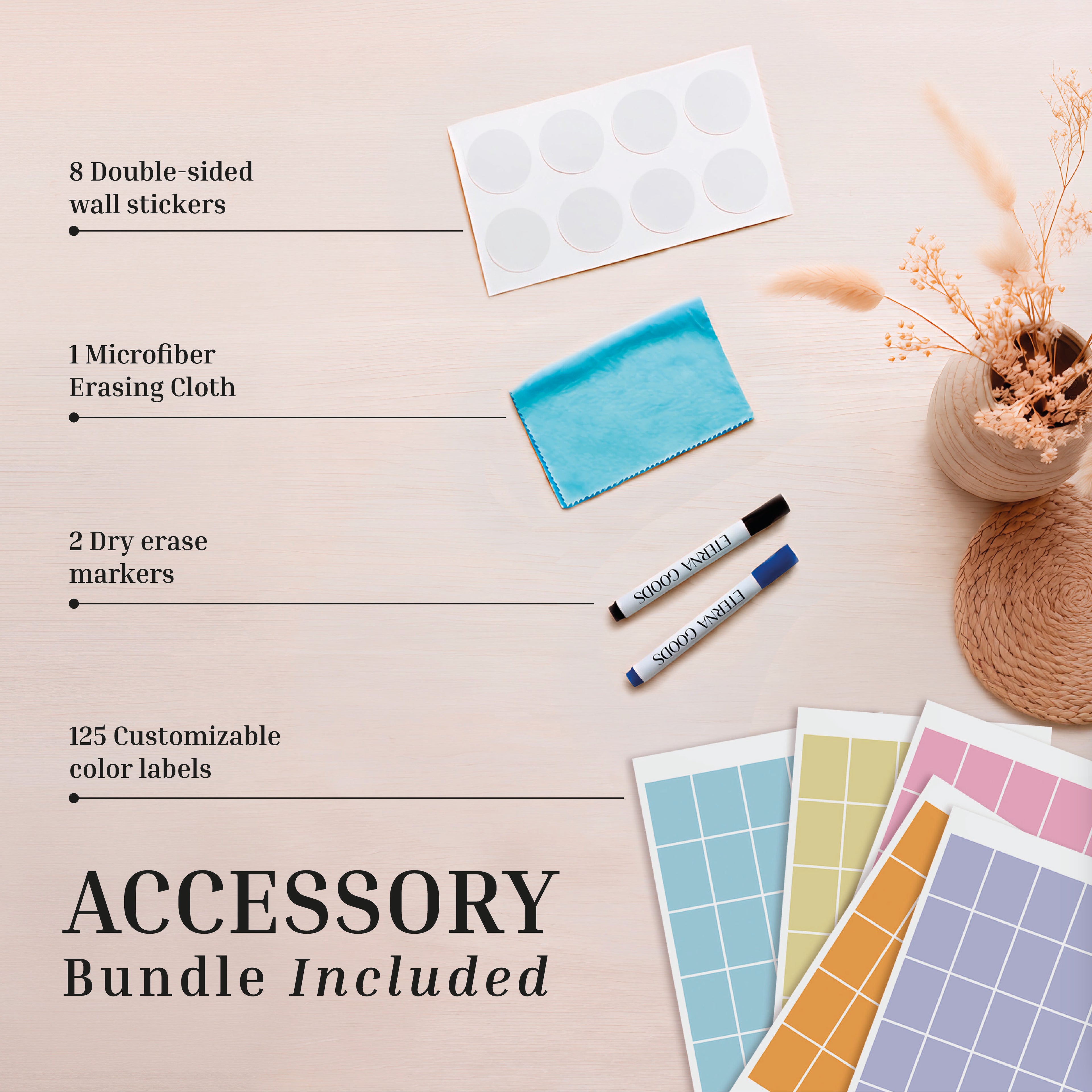 Flat lay of Eterna Goods’ 2026-2027 Midyear/Academic Own The Year Calendar accessory bundle: 8 wall stickers, blue microfiber cloth, 2 dry erase markers, and 125 color labels on a light wooden surface with dried flowers.