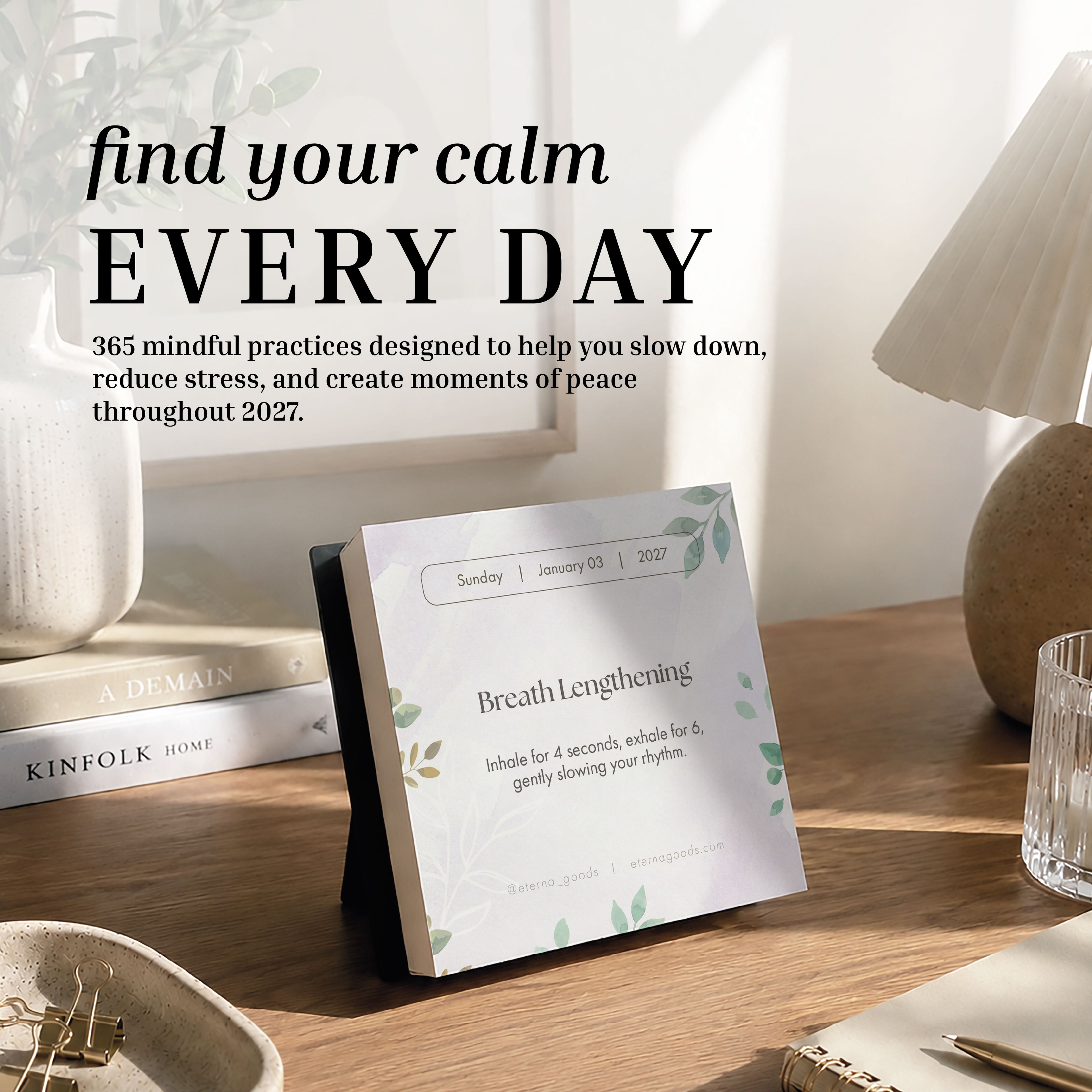 An Eterna Goods 2027 Mindfulness Calendar sits on a wooden table, open to a breathing exercise page, with sunlight and houseplants in the background; text above encourages daily mindfulness exercises and stress relief practices.