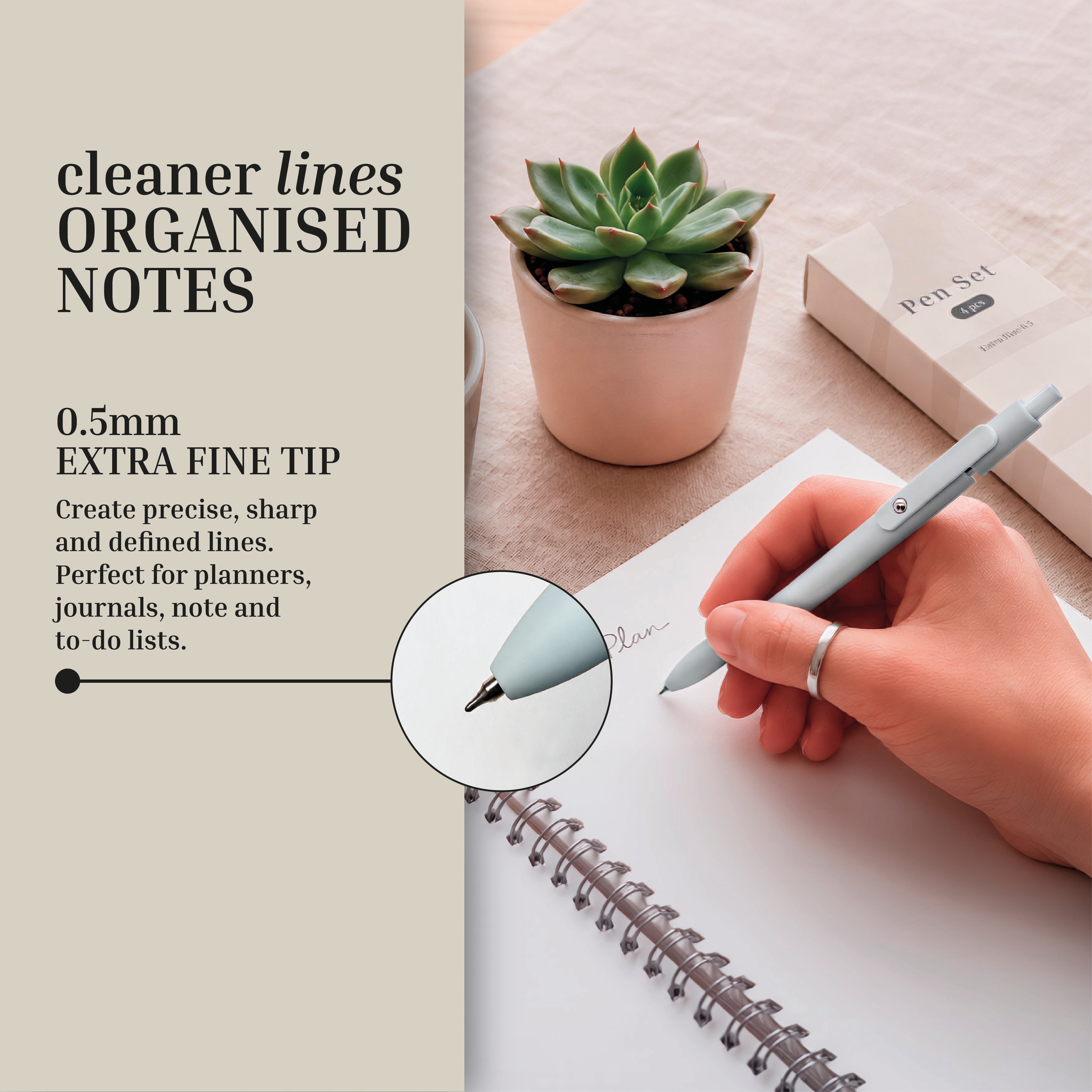 A hand writes in a spiral notebook with a grey 0.5mm Eterna Goods Extra Fine Ball Point Pen, beside a succulent, pen set box, and promotional text highlighting the precision of Eterna Goods writing pens.