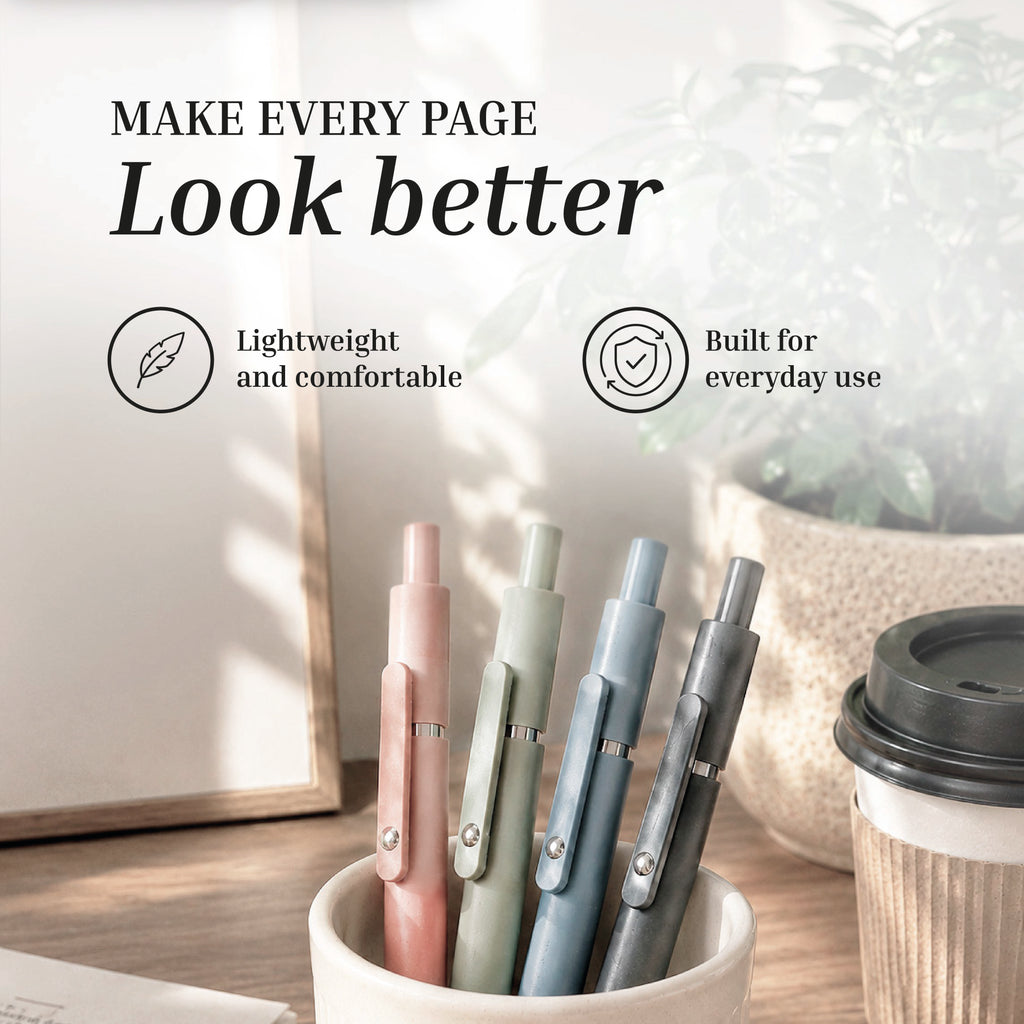 The Eterna Goods Extra Fine Ball Point Pen Set features four pastel 0.5mm pens in a beige cup, shown on a desk with a notebook, plant, and coffee cup. These lightweight pens are comfortable and perfect for everyday writing.
