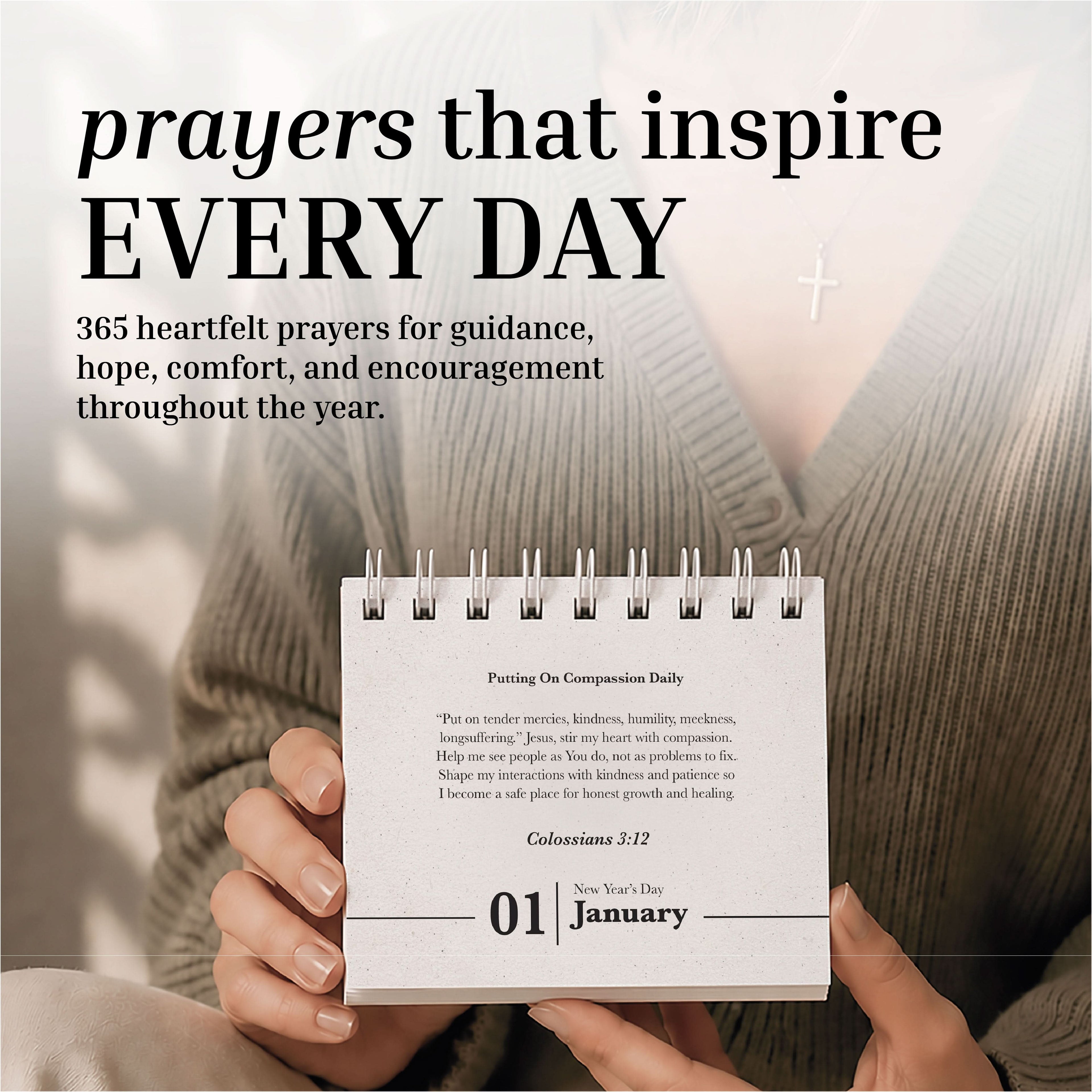 A person holds the Eterna Goods Perpetual Prayer A Day Calendar, a compact spiral-bound calendar featuring January 1, with a cross necklace in view and uplifting prayers from the calendar visible in the background.