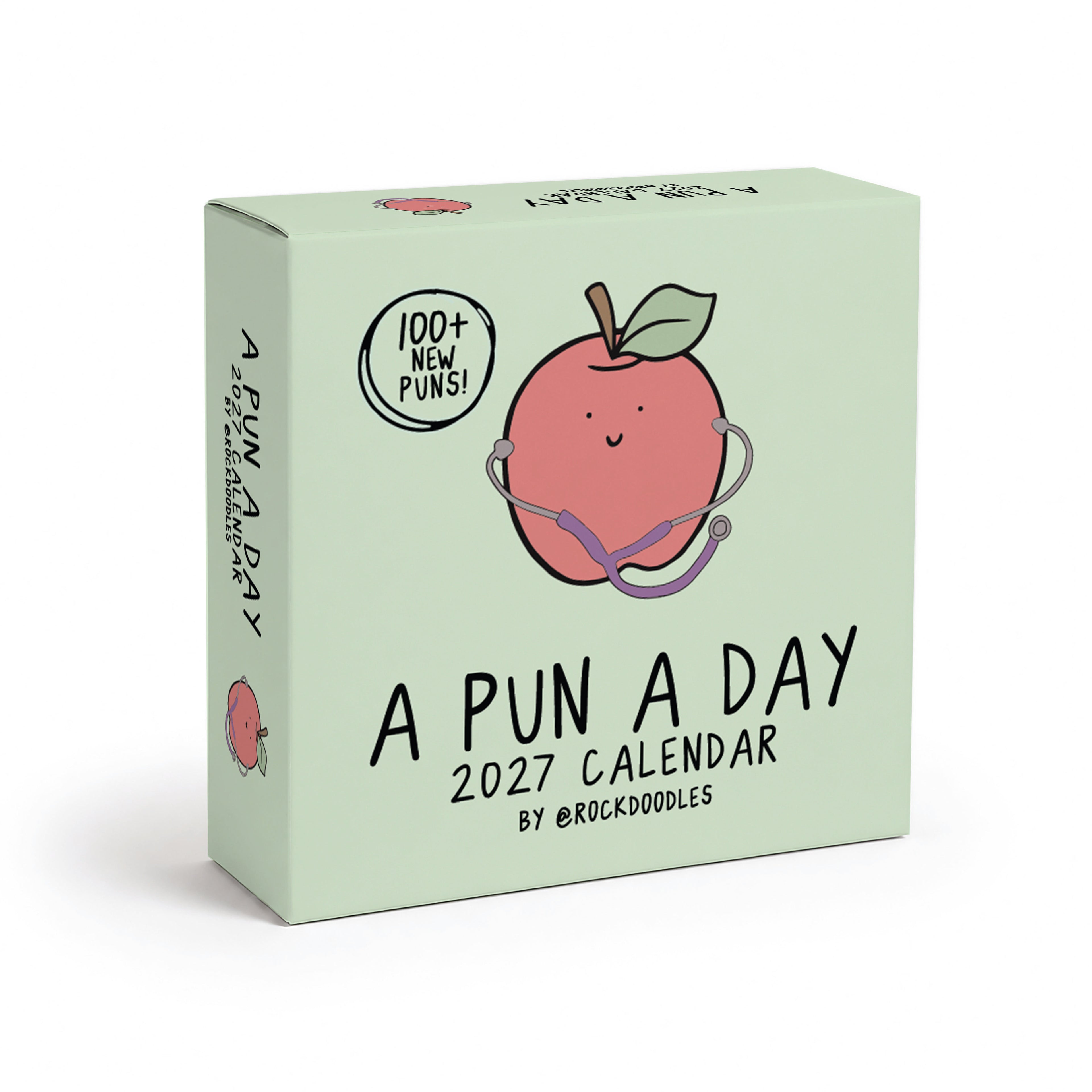 Box for the "2026 A Pun a Day Calendar" by rockdoodles, featuring a cheerful apple with a stethoscope illustration and text showcasing over 100 new puns. This family-friendly daily joke calendar is perfect for anyone who loves to laugh every day!.