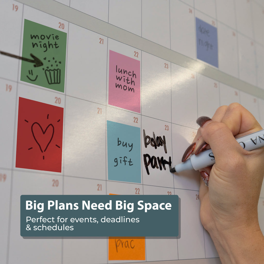 A hand writes "baby part" on a large wall calendar filled with Planning Block Stickers from Eterna Goods—ideal for events, deadlines, and color-coded planning. Text overlay: "Big Plans Need Big Space.