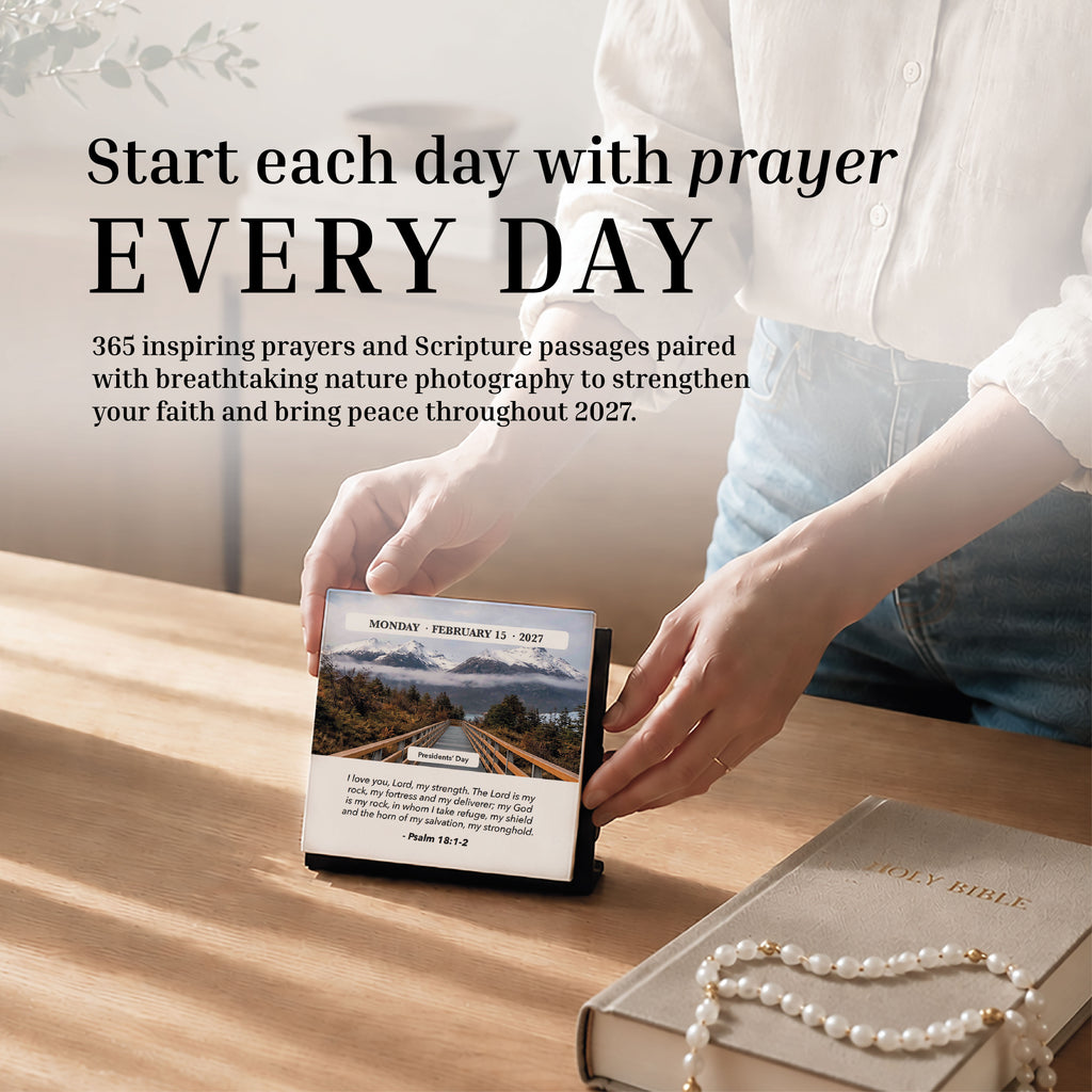 A person opens the Hannah Faith 2027 Verse A Day Calendar on a desk alongside a Holy Bible and beaded bracelet, sunlight pouring across the surface as they seek spiritual growth through daily inspirational Bible verses.