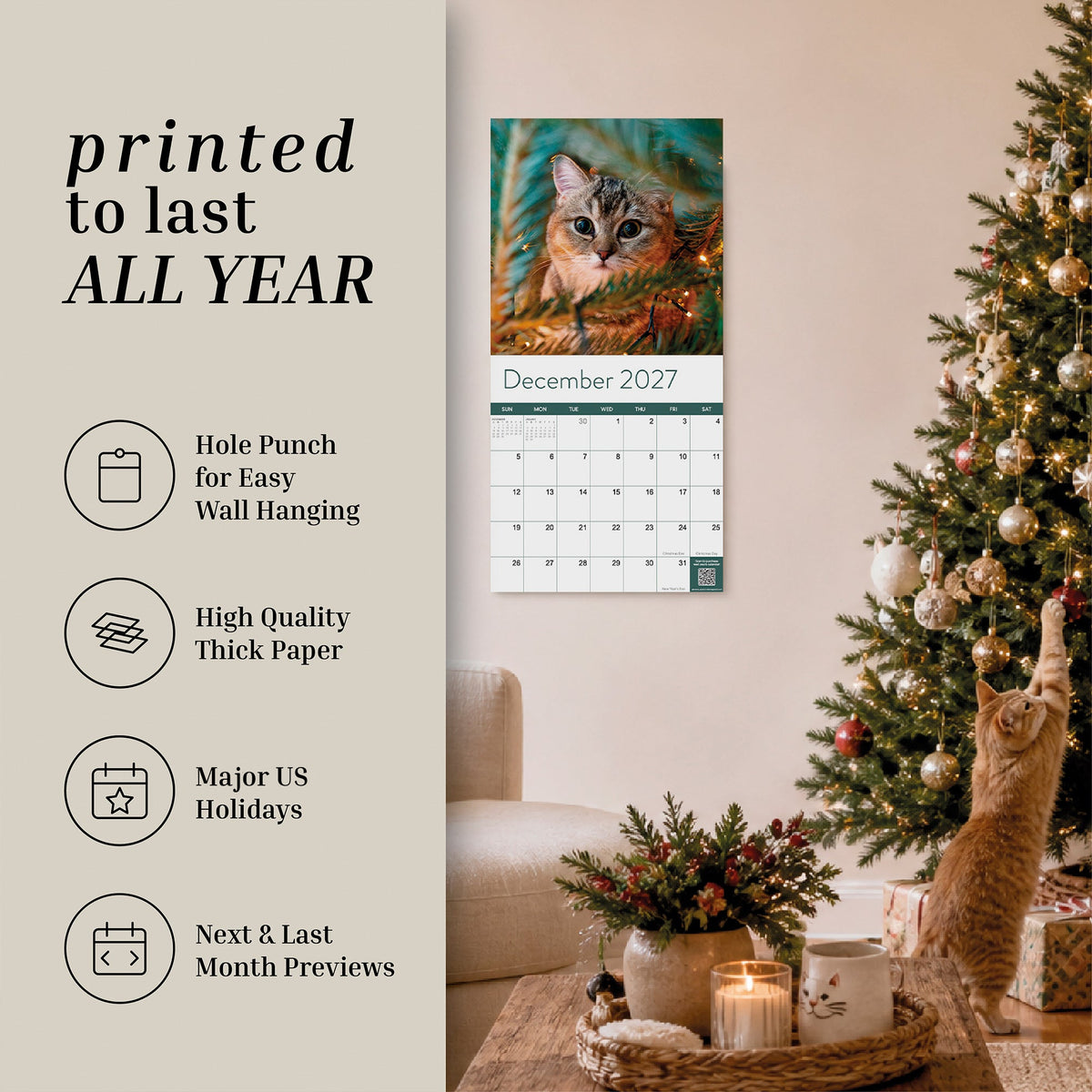 A cozy living room features a decorated Christmas tree, a curious cat reaching for ornaments, and the Eterna Goods 2027 Cats Wall Calendar displayed on the wall, featuring an adorable cat photo for December 2027. The description emphasizes the calendar’s highlights, making it an ideal choice to complete any cat lover’s Eterna Goods Cats Wall Calendar collection.