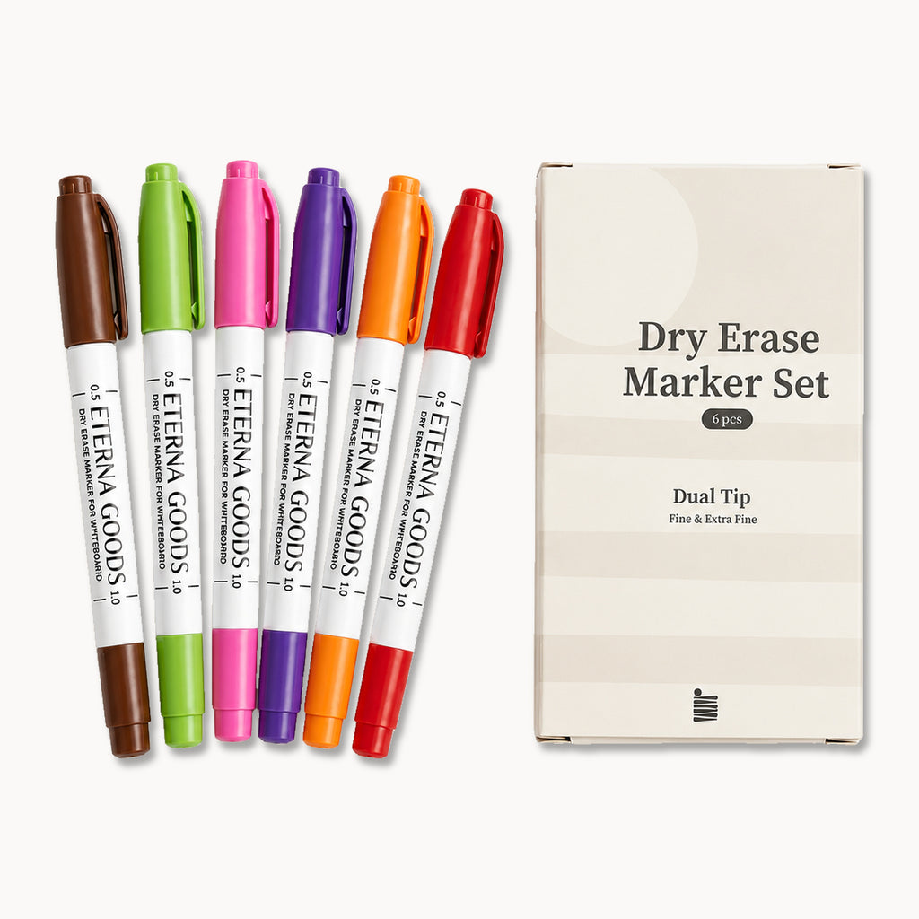 Six vibrant dual-tip dry erase markers, each equipped with a fine tip for precise writing, are arranged beside a white box labeled “Fine Tip Dry Erase Marker Set, 6 pcs, Dual Tip, Fine & Extra Fine” from Eterna Goods.