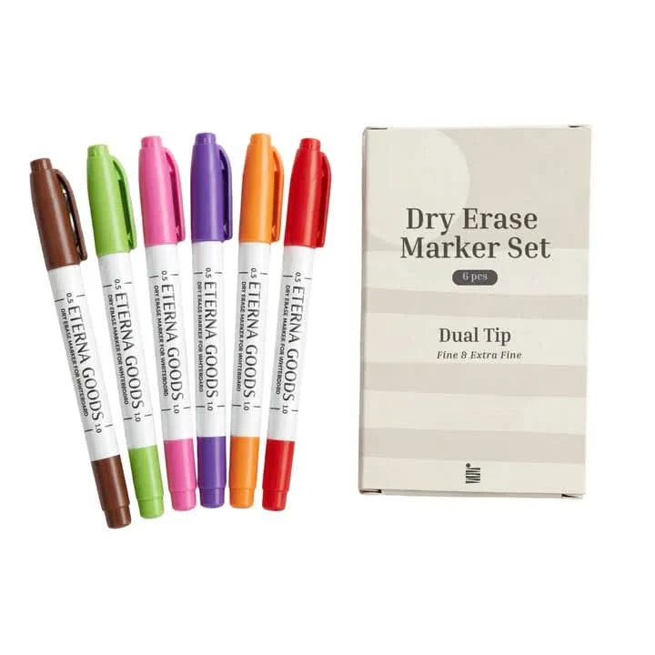 Five dual-tip dry erase markers in assorted colors are neatly arranged next to a box labeled “Dry Erase Marker Set, 6 pcs, Dual Tip, Fine & Extra Fine.” Perfect for pairing with your Ultimate Undated Own The Year Calendar Bundle from Eterna Goods, these markers help keep your plans clear and colorful all year long.