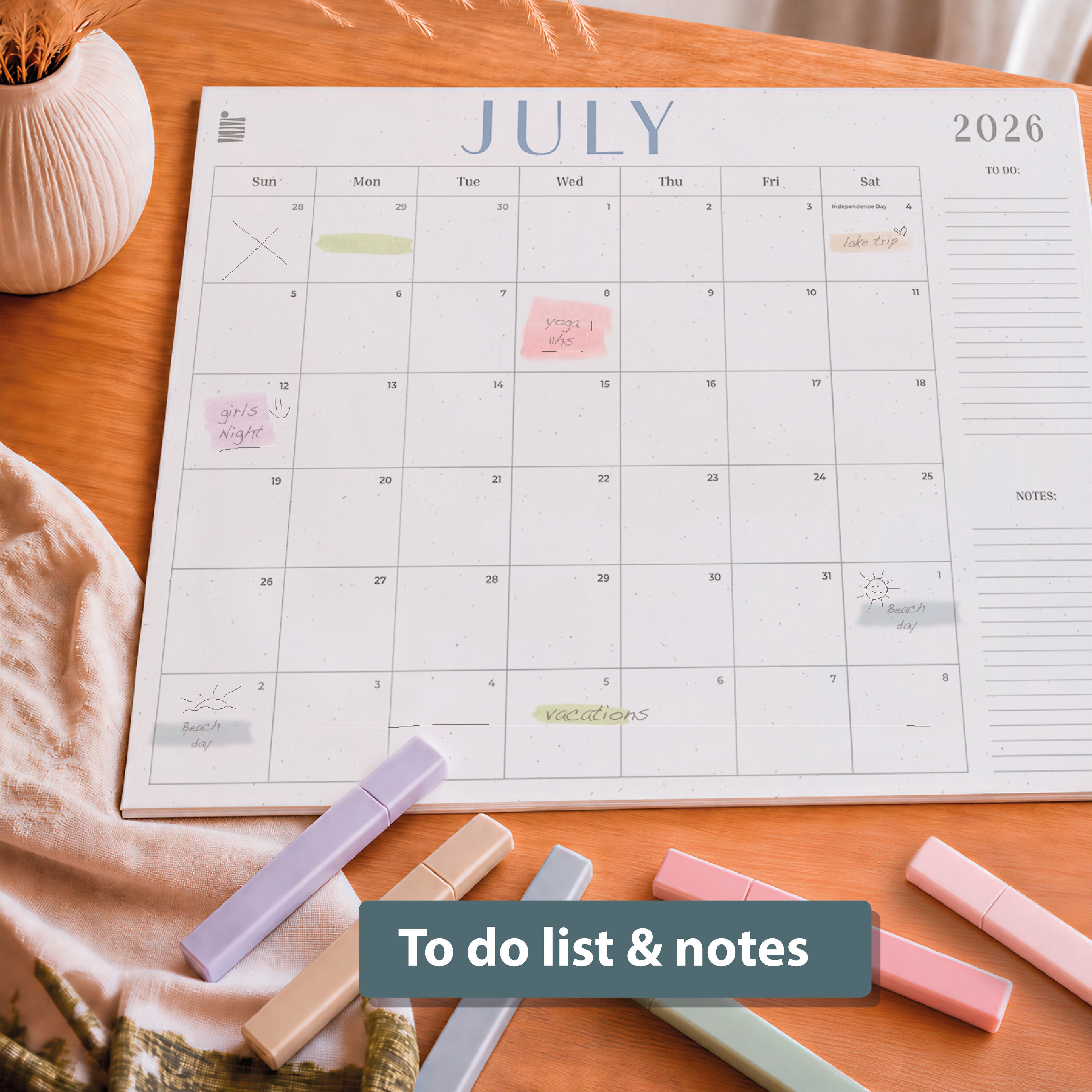 The Eterna Goods 2026-2027 18-Month Flat Desk Calendar (22"x17") lies on a wooden surface with large writing space, handwritten notes, and pastel highlighters; text overlay reads "To do list & notes.